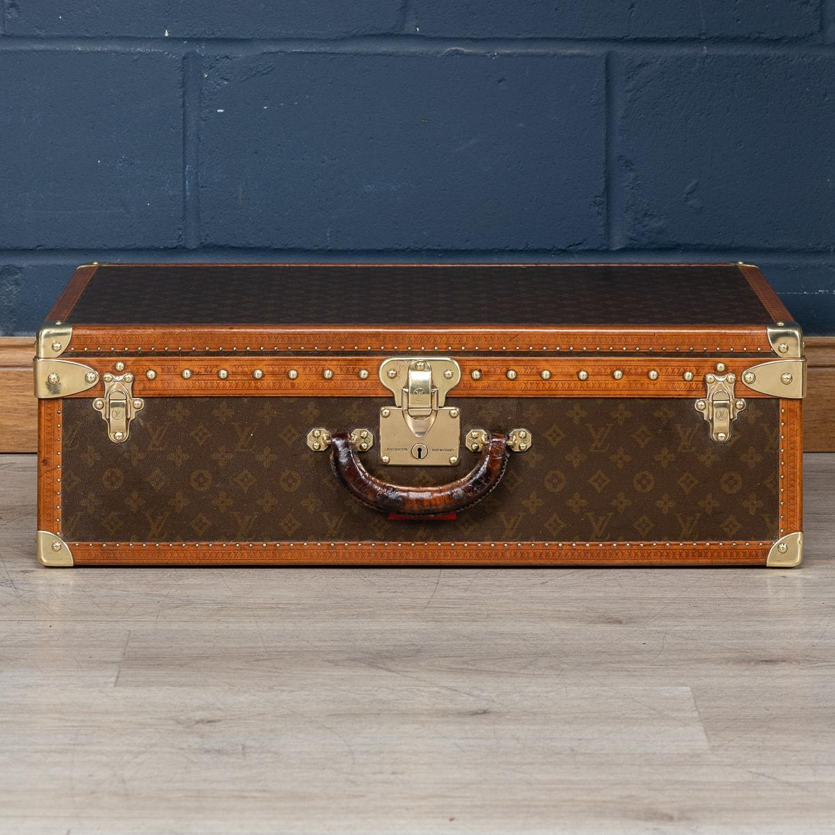 A highly unusual and exceptionally rare Louis Vuitton suitcase, originating from the early years of the 20th century, distinguishes itself not with the globally renowned monogram canvas but with a distinctive covering crafted from a singular piece