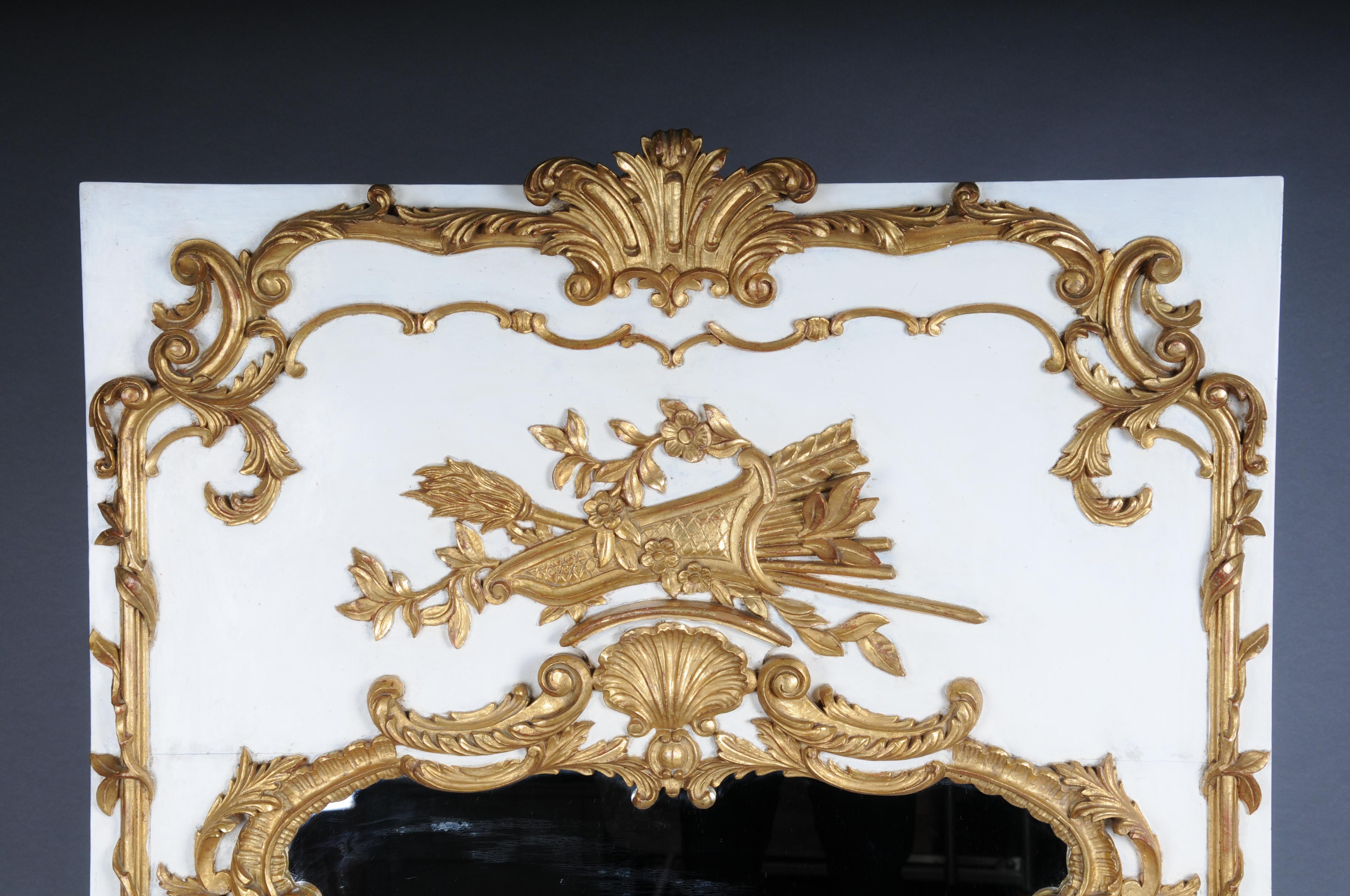 20th Century Louis XV gilt wall mirror, white

Tall rectangular wooden body plate with richly ornate carved decorative elements on a white background, crowned with a quiver and arrows. Extremely decorative and noble. Finely carved wooden