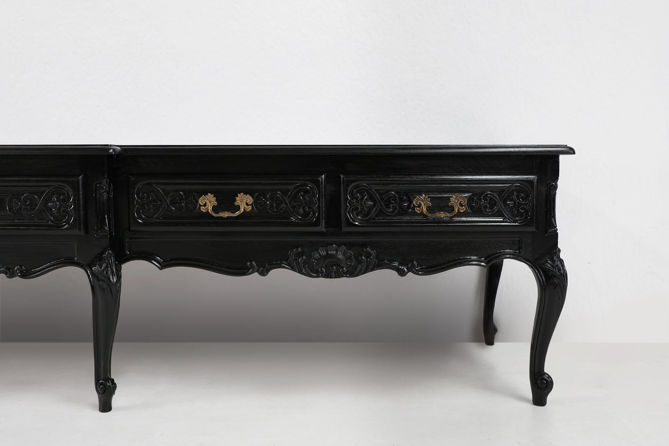 France / 1950 / low sideboard / wood / Louis XV / Queen Ann / French

A 20th century black lacquered low sideboard in Louis XV style made in France. This stylish low sideboard has five spacious drawers that provide ample storage for your essentials.