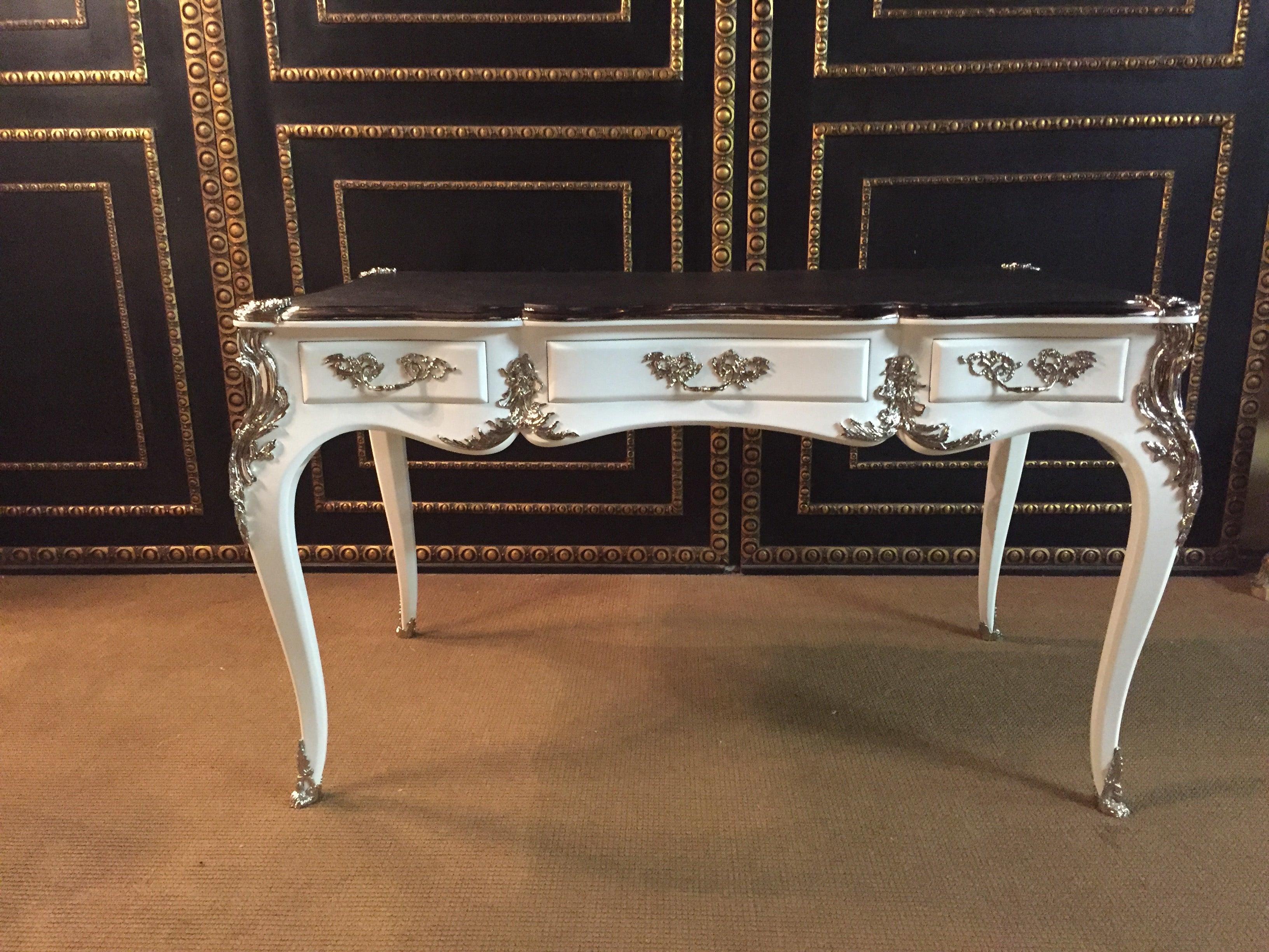 Bureau plat writing table in the style of Louis XV style, silvered bronze fittings. Piano lacquer white on solid beech wood. Heavily arched, four-sided passively curved tripod frame with wide knee lug on elegant curved squares in the drive boxes.