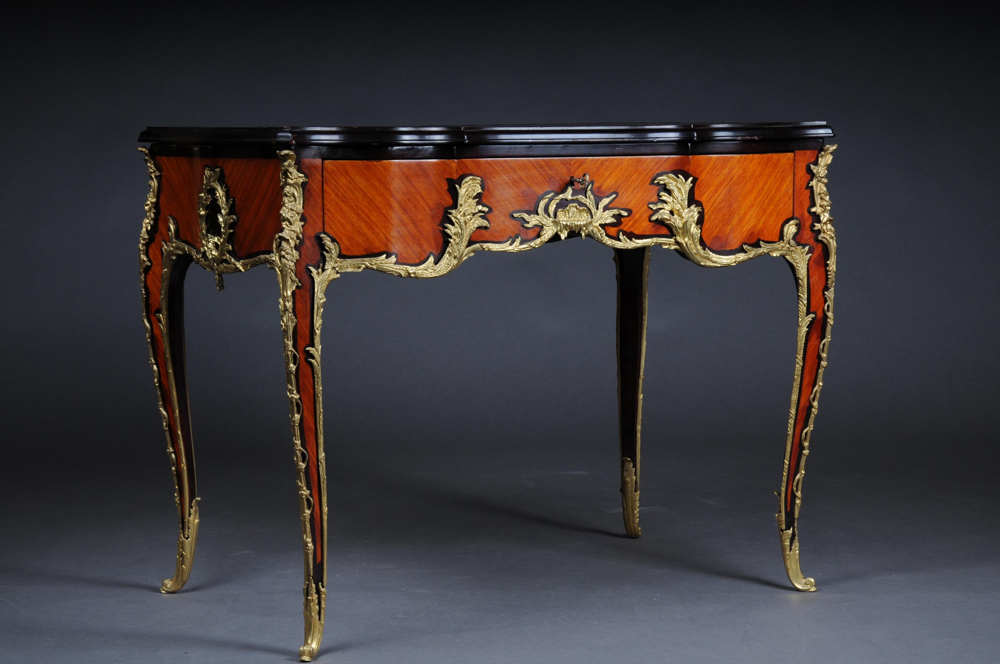 20th century Louis XV style French Bureau plat or desk after Francois Linke

Table top covered with genuine high quality leather and gold embossing
Tulip wood and shadowed noble woods, veneered. Exceptionally fine floral, bronze fixtures.