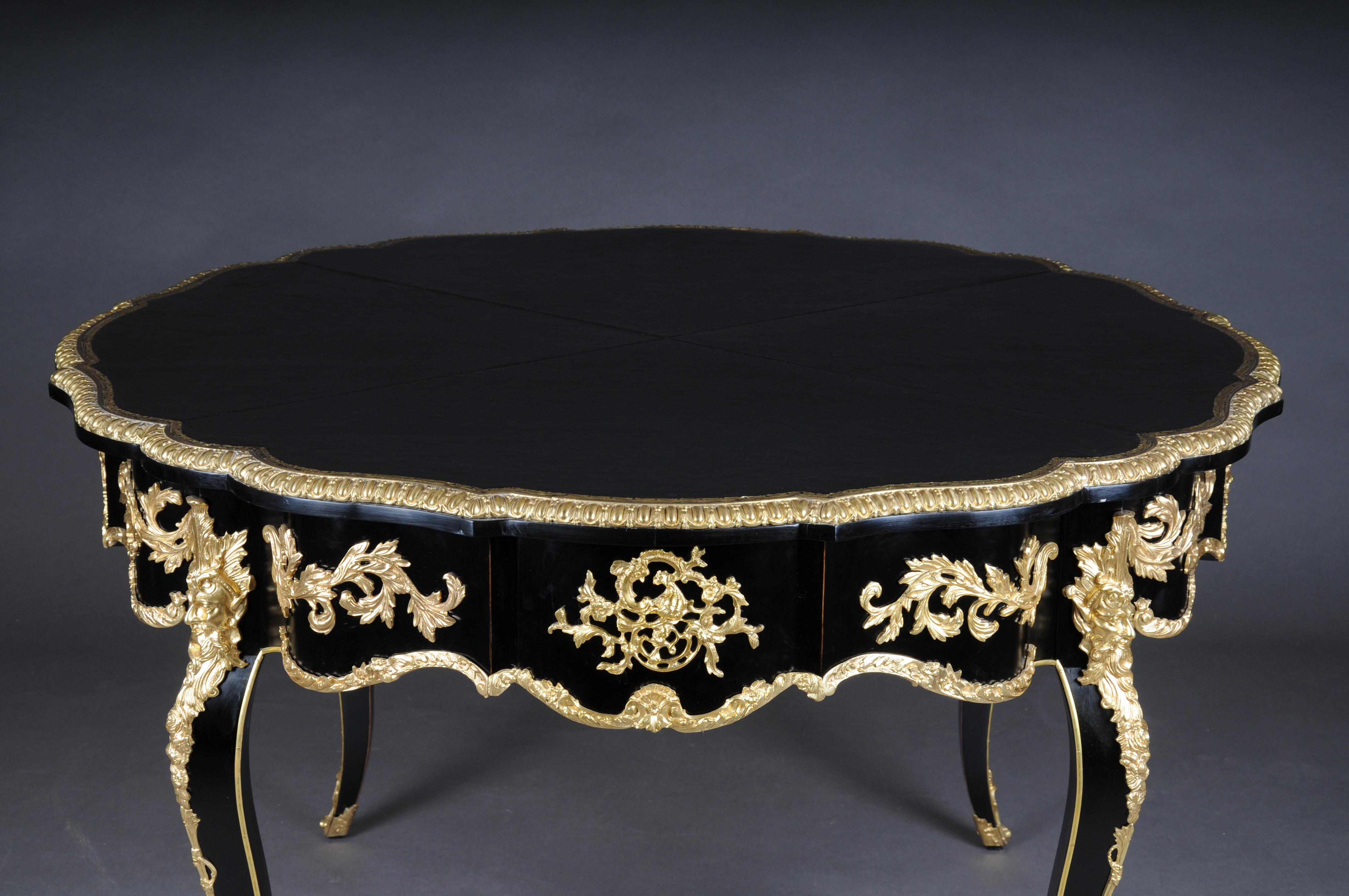 Majestic French 20th century Louis XV style Salon table, black gold.

Table top made from the finest genuine leather with gold embossing.
Table made of solid beech, chattered. Very rich gilded bronze fittings. Coffee table with an inconspicuous