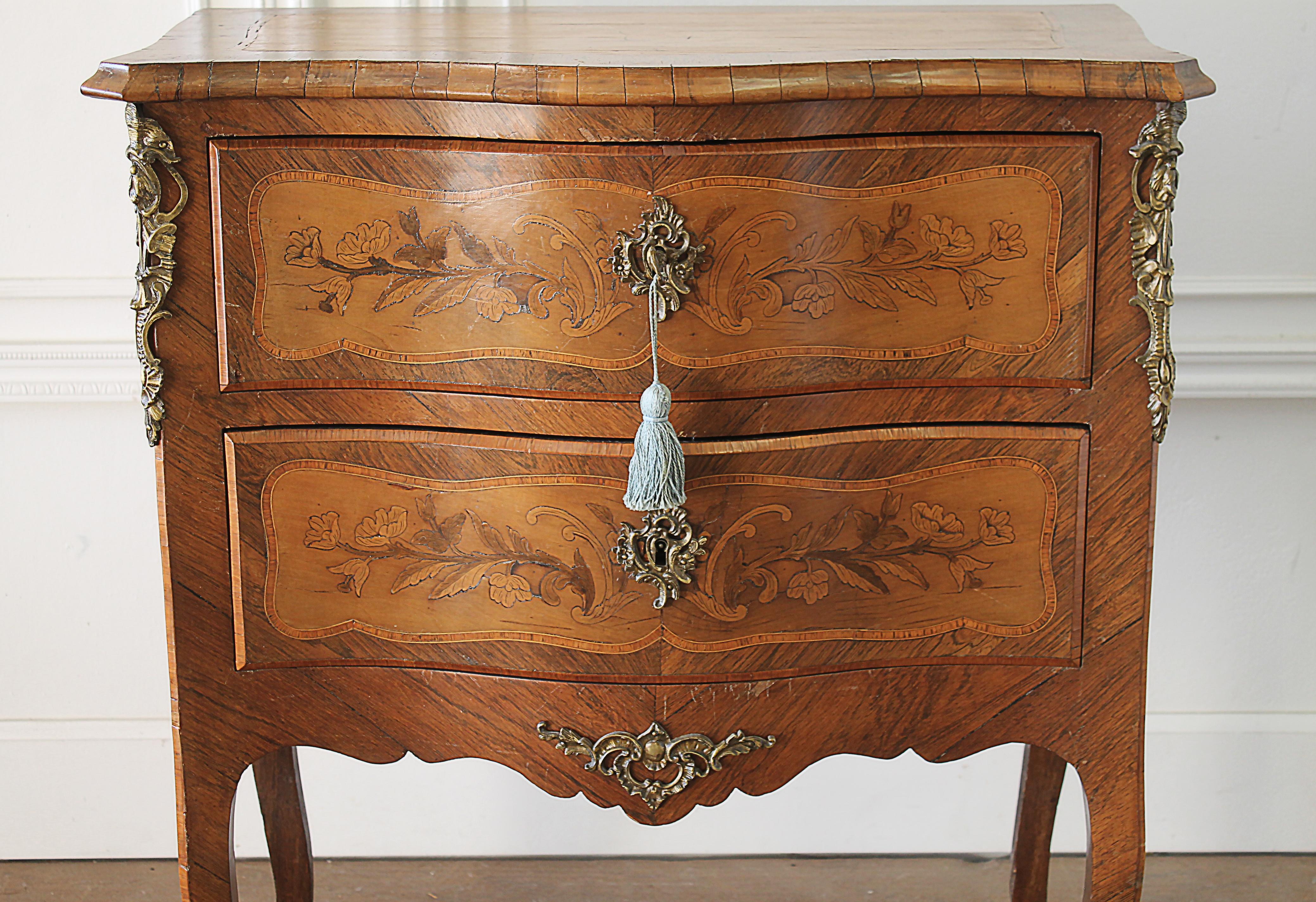 20th century Louis XV style inlay commode with bronze mounts
Beautiful 2-drawer commode with wonderful floral a shell inlays. Original working key and tassel included. This piece has a beautiful aged patina, and is solid and sturdy, great for