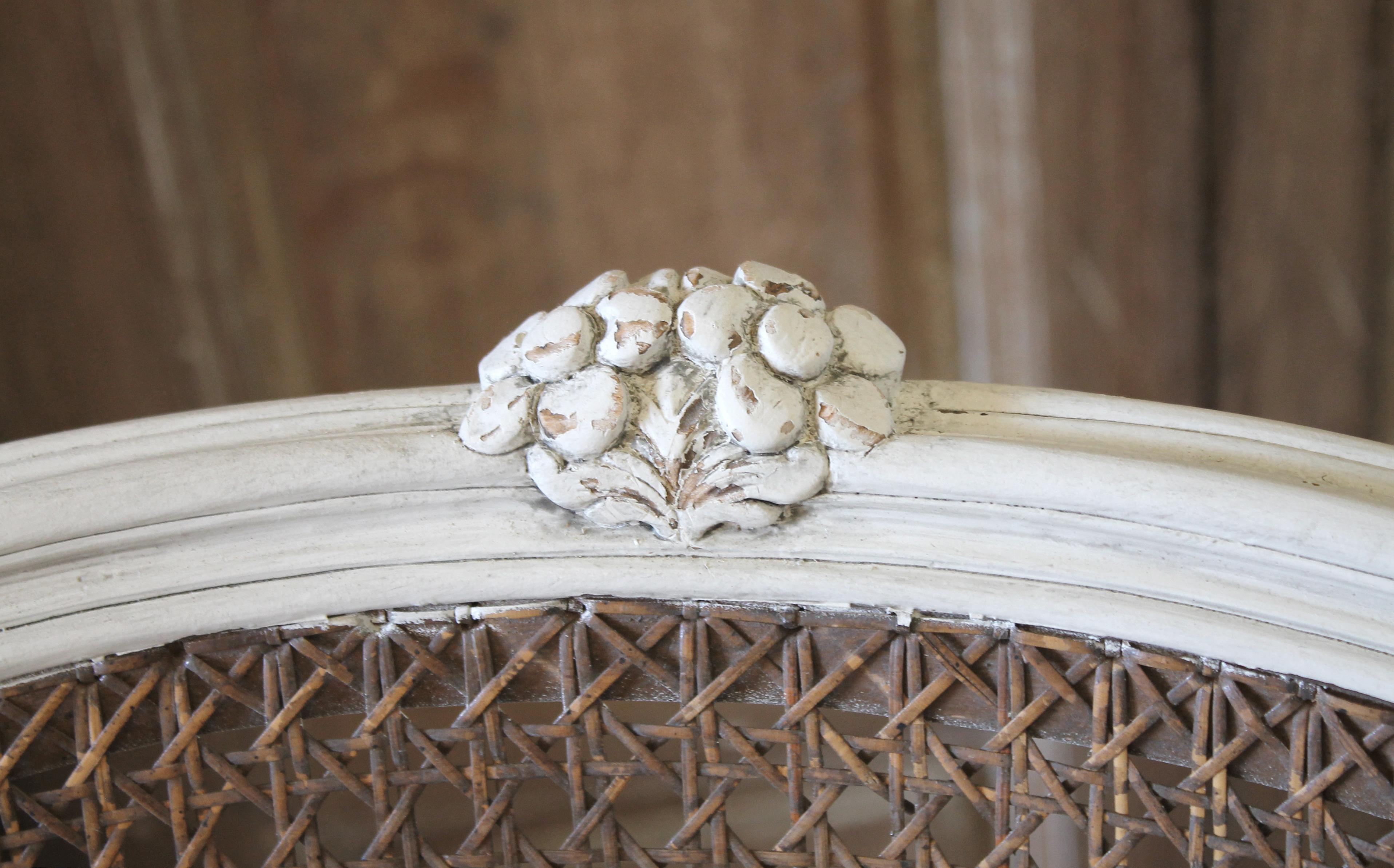 20th century Louis XV style swivel vanity chair with cane.
Finished in our signature oyster white finish, with subtle distressed edges, and antique patina. The cane is a medium brown color with no breaks or damage. The seat swivels, while the base