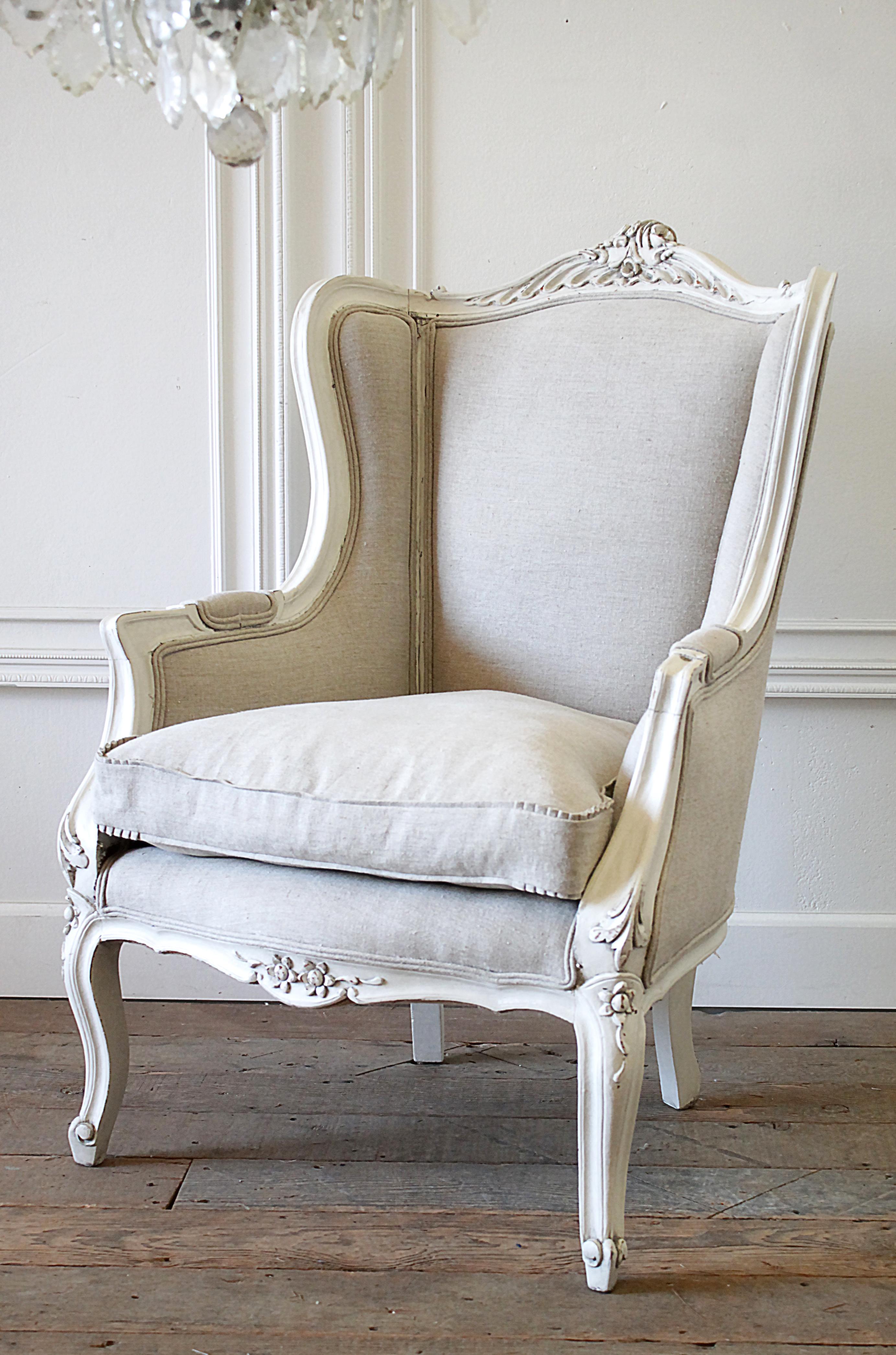 20th century Louis XV style wingback chair new Belgian linen upholstery.
Painted in our soft oyster white, which is a soft white with subtle distressed edges, and finished with an antique glaze patina. Paint color blends well with warm and cool