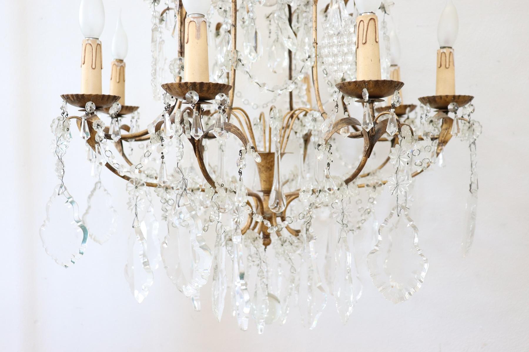 Beautiful and refined Italian Louis XVI style, circa 1940s chandelier eight lights. In gilded bronze and completely covered drops of crystal. The crystal exudes the typical brightness; the drops are finely worked giving an elegant light. The