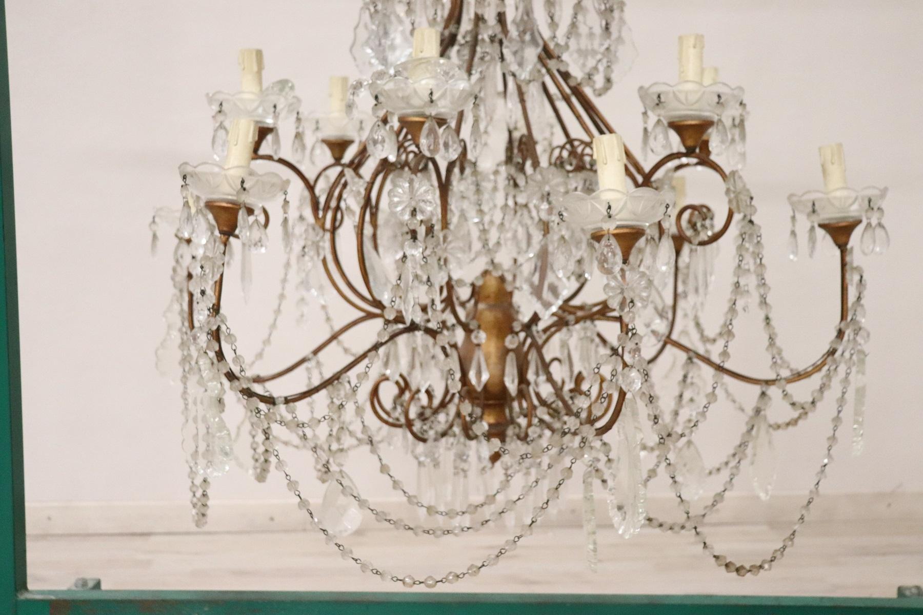 Beautiful and refined Italian Louis XVI style, circa 1940s chandelier eight lights. In gilded bronze and completely covered drops of crystal. The crystal exudes the typical brightness; the drops are finely worked giving an elegant light. The