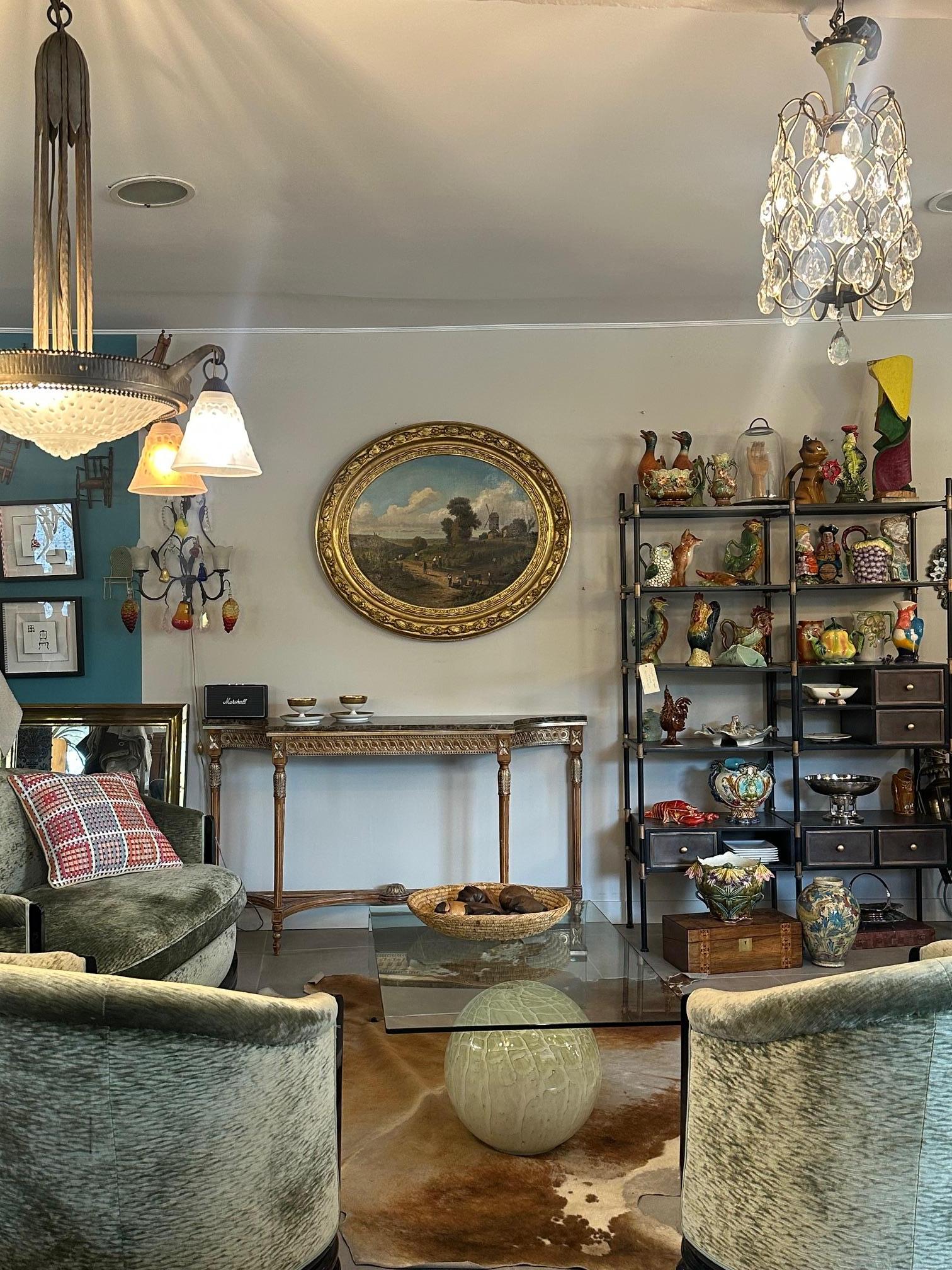 Elegant console table dating from the 1950s in Louis XVI style, harmoniously combining a carved and gilded wooden base with a veined brown marble top.
Its refined decoration of scrolls, rosettes, and fluting gives it a timeless classical look,