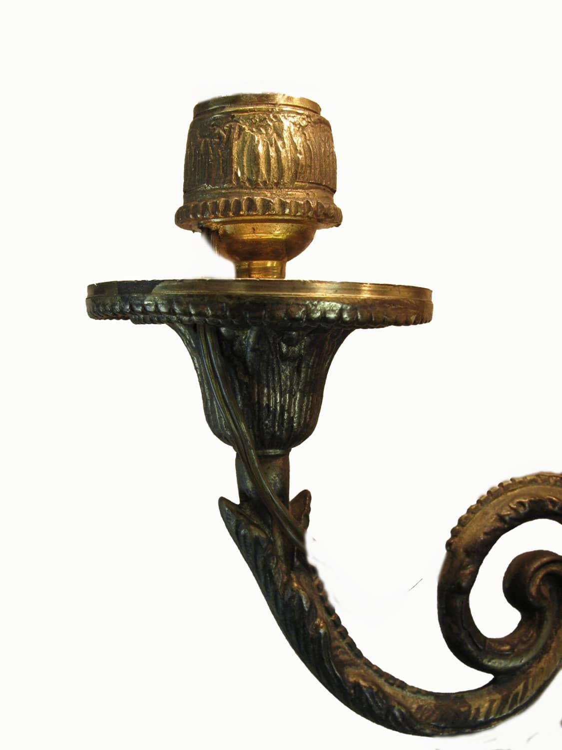 Set of three 20th century Louis XVI style Italian bronze three-arm sconces, in good condition, with a still working Italian standard wiring, suitable for three Edison 14 bulb lights.
Any wall lamp features three scrolling curved arms, topped by an