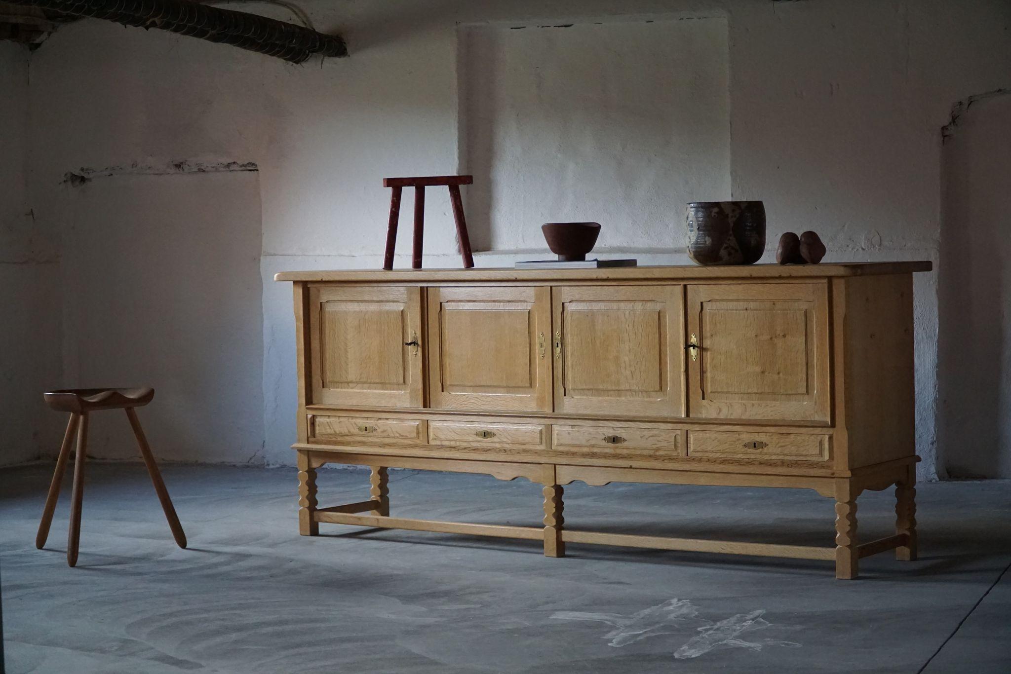 A sculptural low rectangular classic sideboard / cabinet in solid oak with plenty of storage and a nice carved front design. Made by a Danish cabinetmaker in ca 1960s. 
This piece is in a good vintage condition.

This nice brutalist sideboard