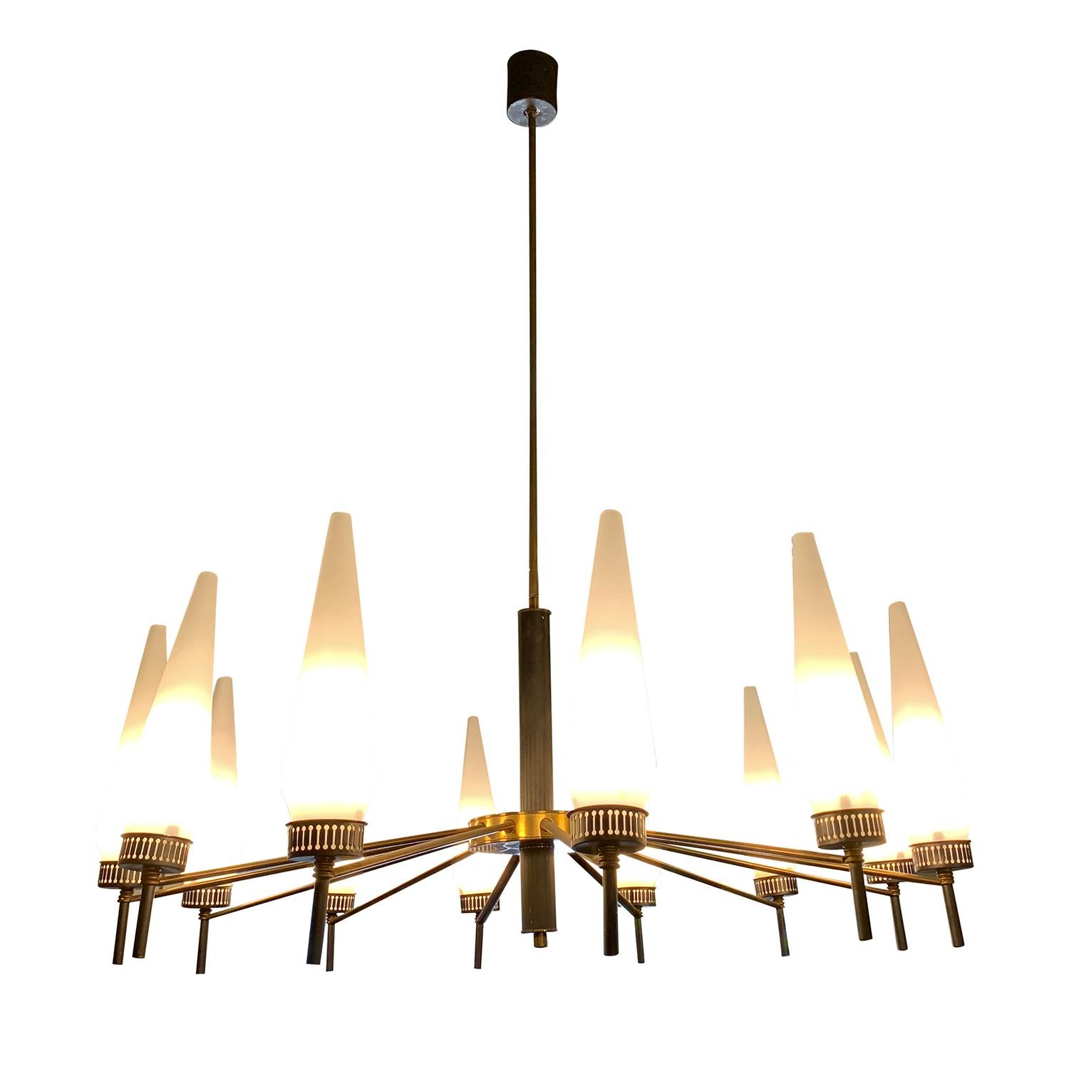 A vintage Mid-Century Modern Italian lustre, lighting fixture made of handcrafted metal and brass, in good condition. The round chandelier, pendant is composed with twelve hand blown frosted opaline glass shades, each of is featuring a one light