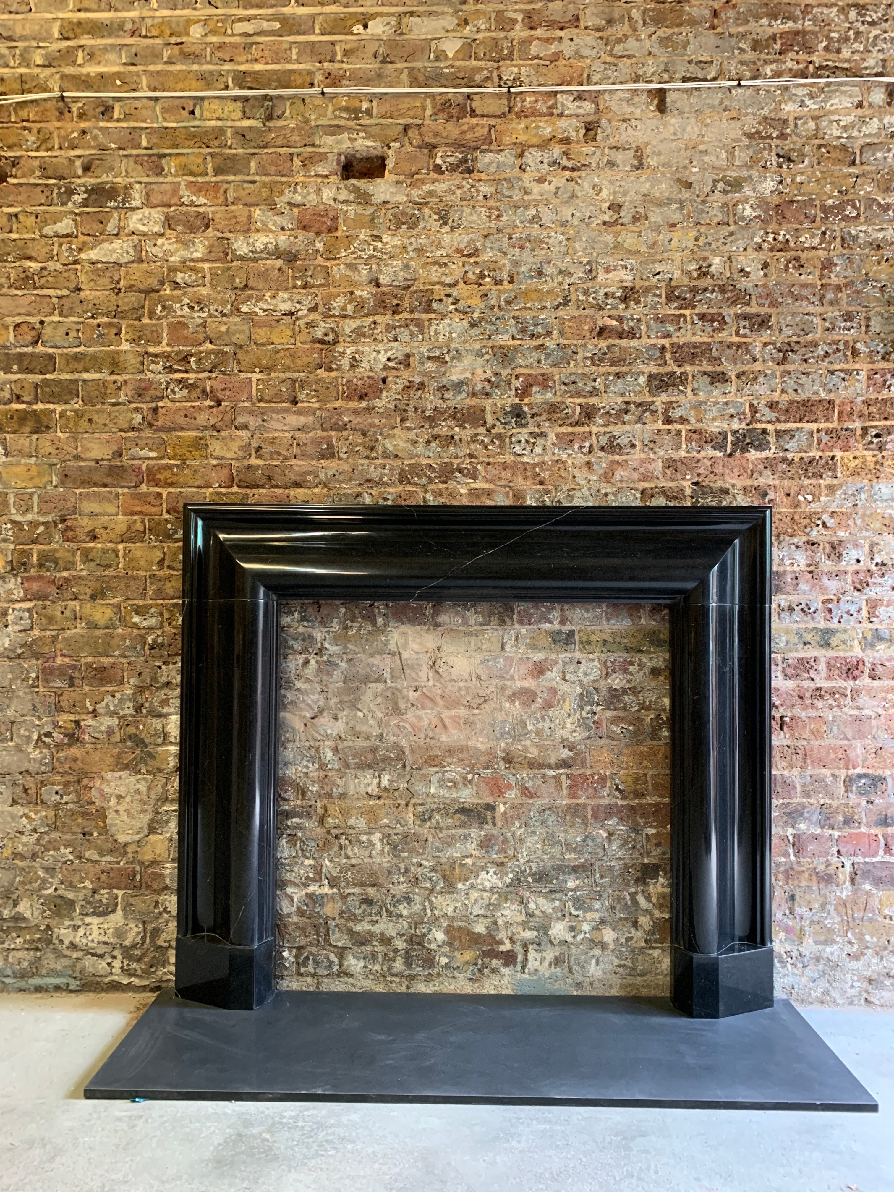 20th Century Mable Bolection fireplace surround.
Hand carved In Nero Marquina natural marble - from solid block.

Width 60 inch
Depth 4. 13/16 inch
Height 50. 75 inch
Opening width 40 inch
Opening height 40 inch
Rebate 1 inch.