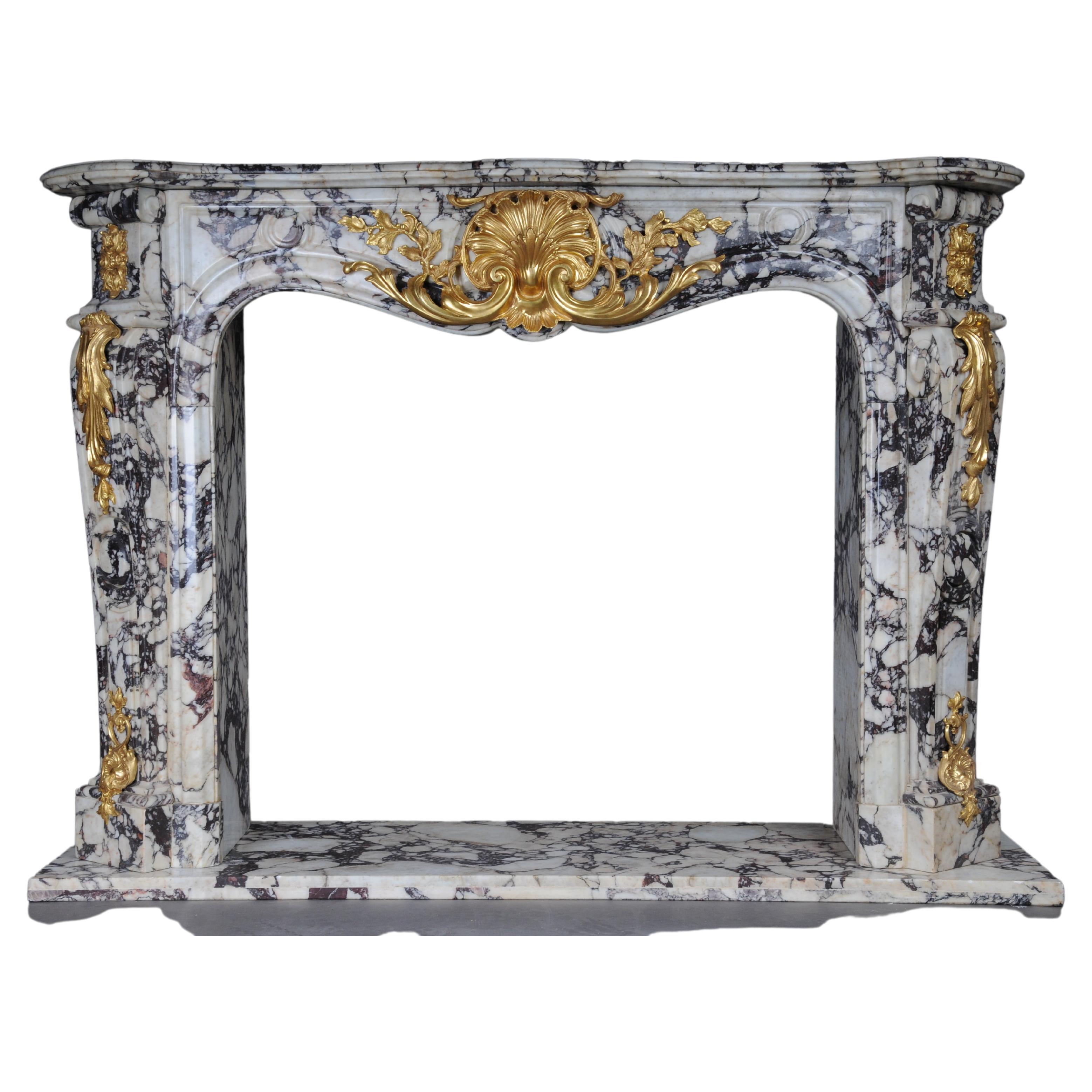 20th Century Magnificent French marble fireplace with gilded bronze.