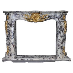Vintage 20th Century Magnificent French marble fireplace with gilded bronze.