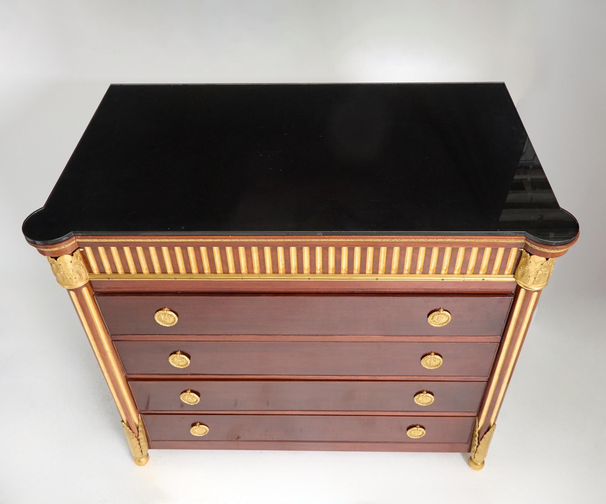 This refined mahogany server/credenza showcases exquisite craftsmanship with bronze ormolu mounts and versatile design features. The front displays four drawers with brass pull hardware; the top two open to reveal a convenient flat-front desk
