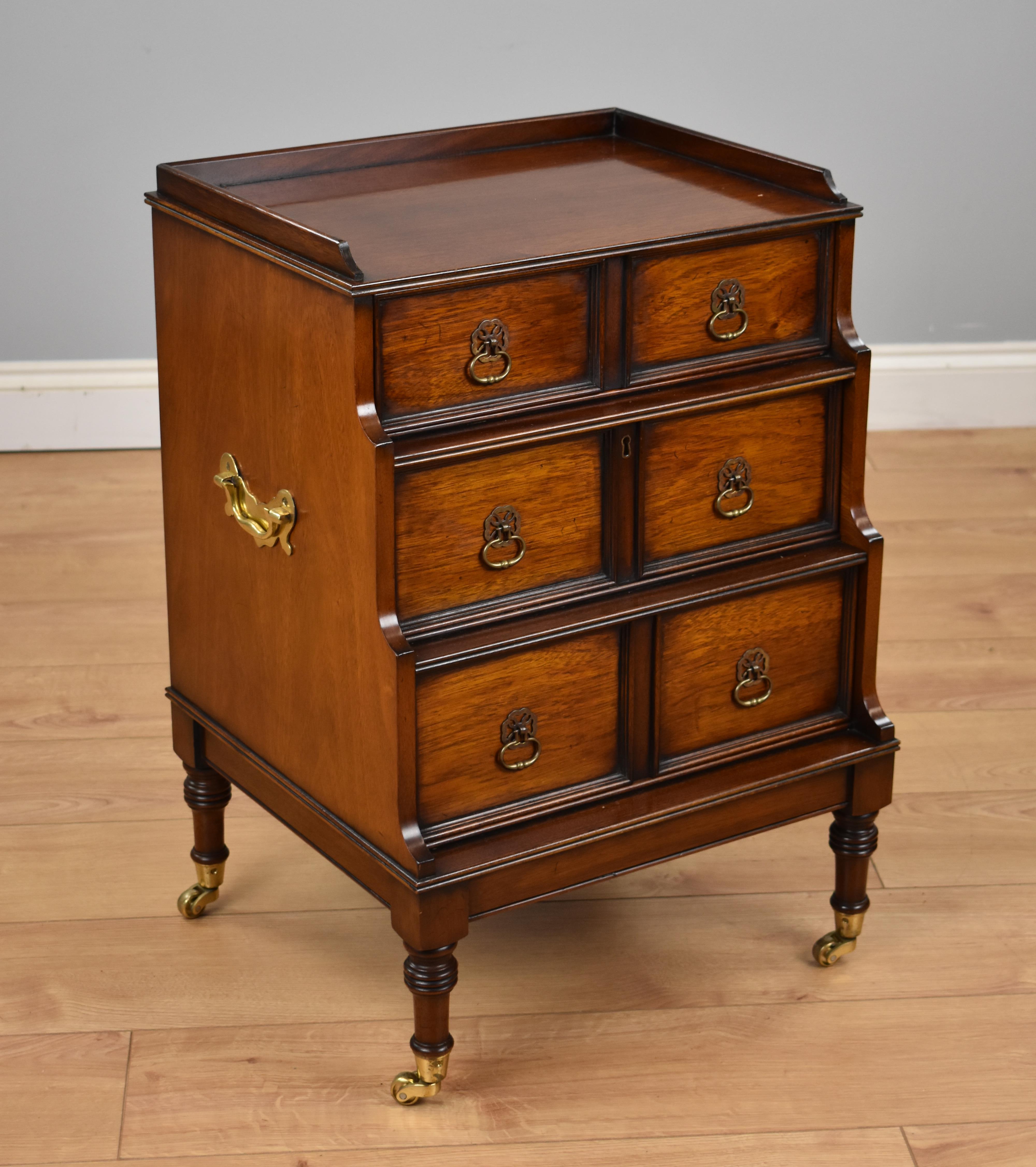 Unusual 20th century mahogany file cabinet in good condition, the cabinet has a single drawer to the top with file drawer below, all with drop handles and carrying handles to either side, standing on small tapered legs on castors.