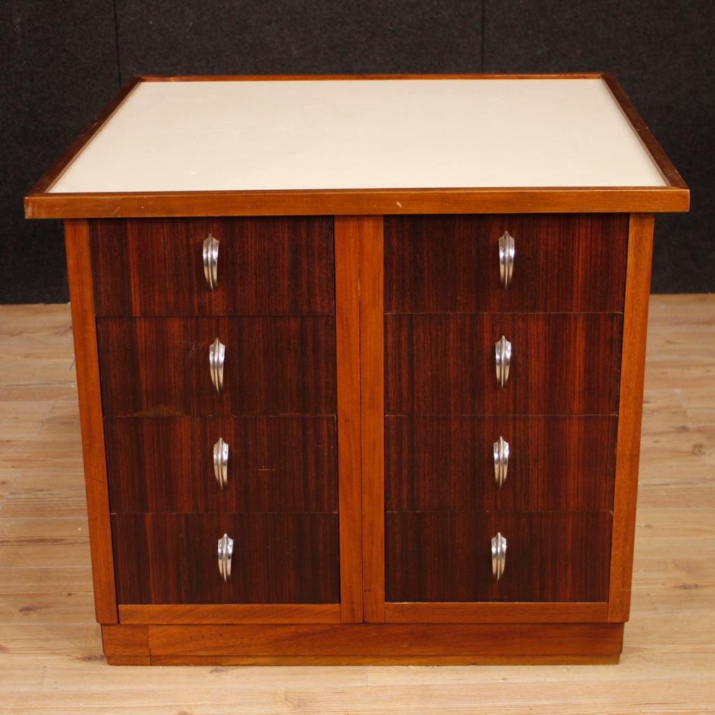 French chest of drawers from 20th century. Furniture of particular shape and construction in mahogany, palisander and beech wood adorned with handles in chromed metal. Chest of drawers finished for the centre, equipped with 8 frontal drawers of
