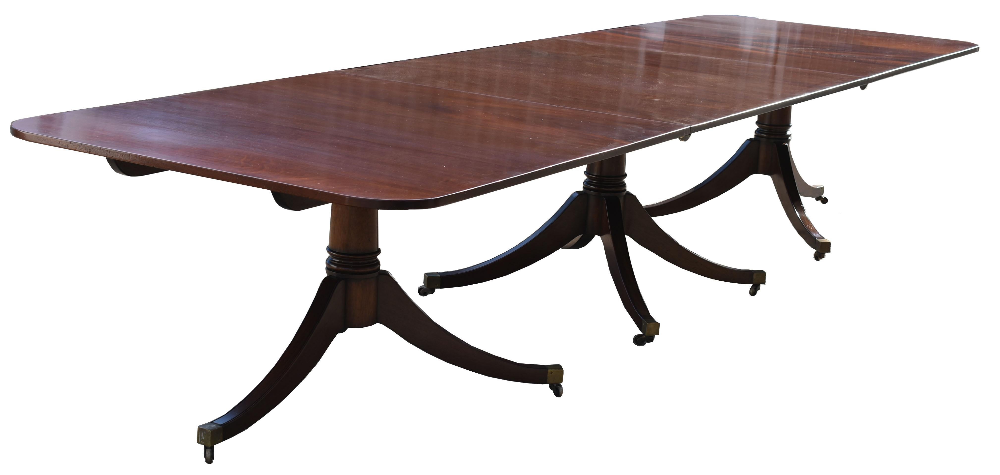 For sale is a good quality 20th century Regency style mahogany dining table, standing on three pedestal bases, each having splayed legs terminating on brass castors. The table is in excellent condition. 

Measures: Length (three pedestals):