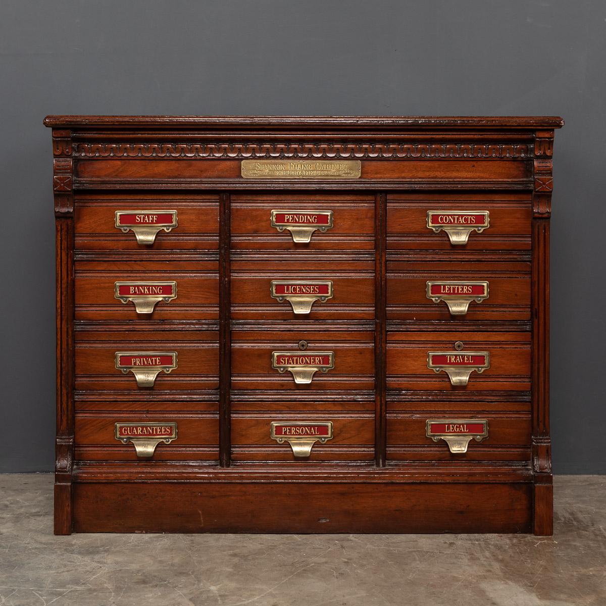 Antique early 20th century hand crafted mahogany filing cabinet, 'The Shannon Filing Cabinet, manufactured, patented by Schlight & Field Co, Rochester NY USA'. This piece has twelve retractable drawers with original brass hook handles, each draw is