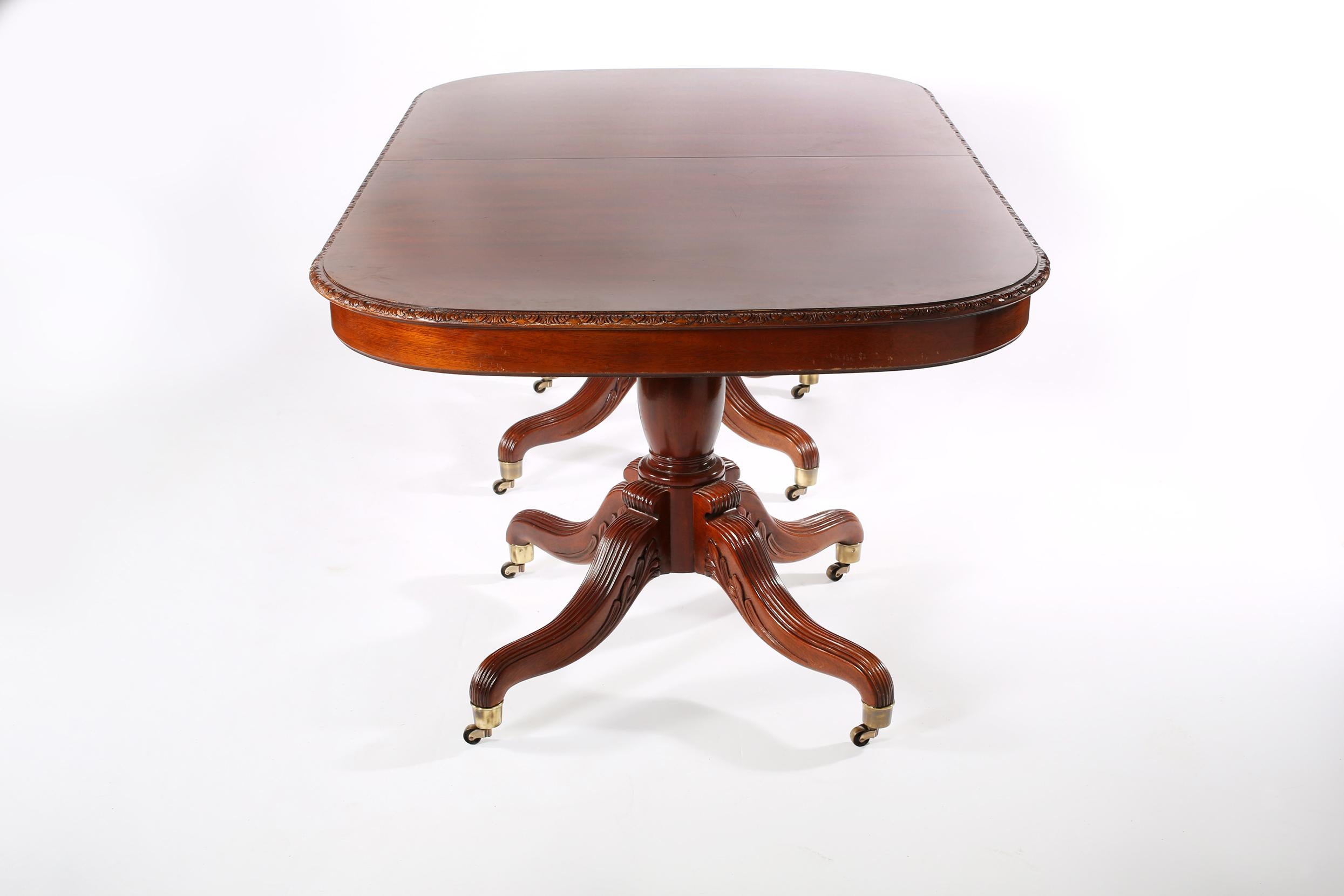 Finest craftsmanship of mid-20th century North American mahogany wood dining room table with three extension leaves. The table is in great vintage condition with minor wear consistent with age / use. Maker's mark undersigned. The table is about 78