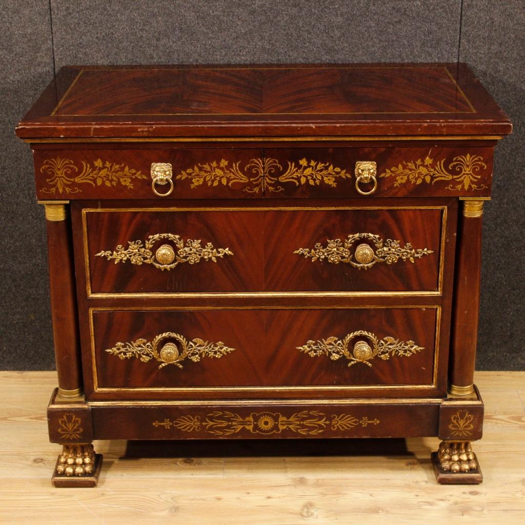 French dresser from the second half of the 20th century. Fabulous Empire-style furniture in mahogany wood. Dresser richly adorned with brass inlays, side columns and decorations in gilded and chiseled bronze. Small chest of drawers with a wooden top