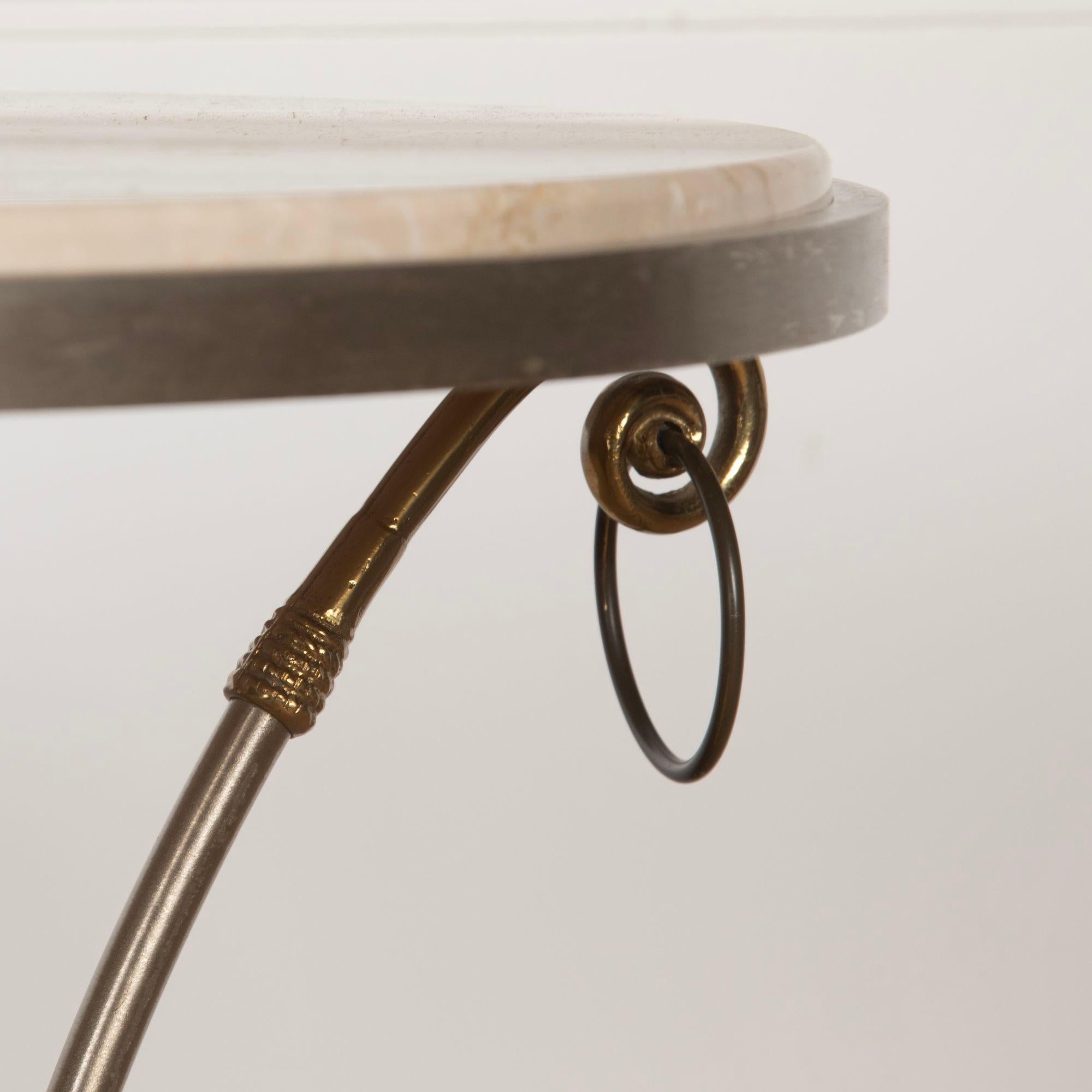 Chic Neoclassical Revival steel and brass occasional table with inset travertine top.
Attributed to Maison Jansen.