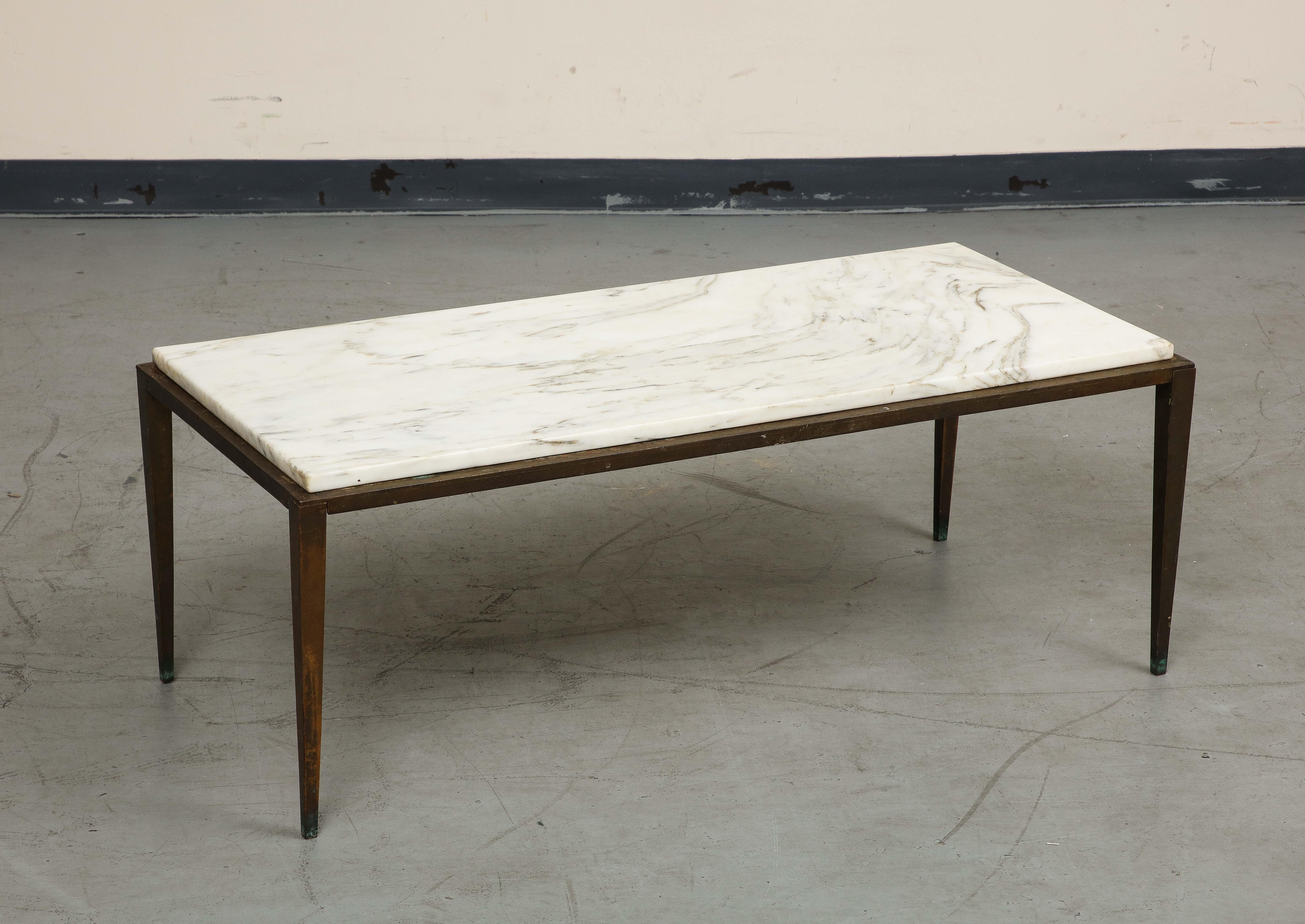 20th century coffee table in the style of Maison Ramsay. The Carrara marble top sits on a bronze and iron base with tapering legs, unmarked, 16.5