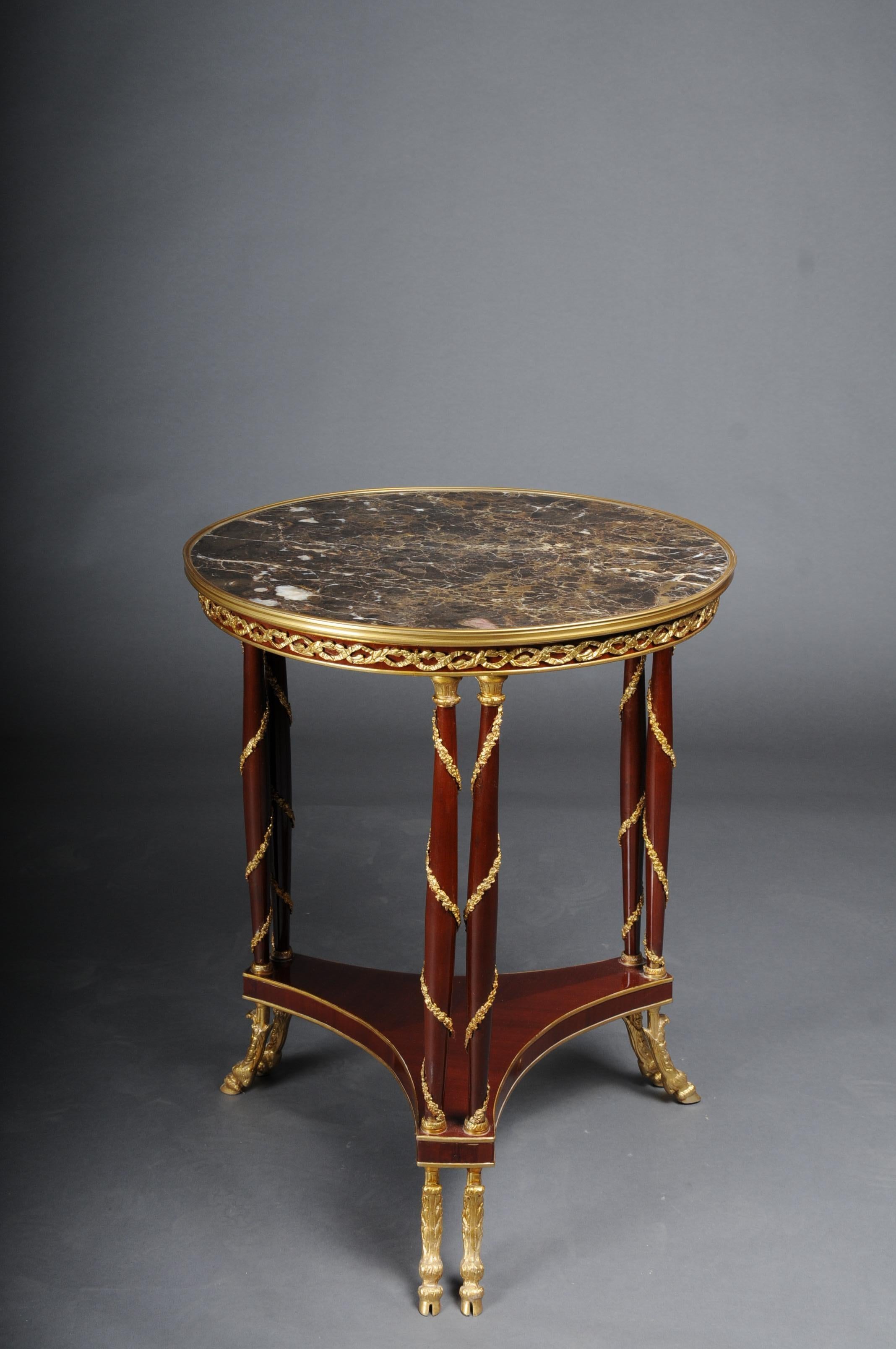 20th century Majestic Empire Salon table/Gueridon, beechwood, marble

Solid beech wood, with gilded brass bronze. Top plate with brass-framed marble top.
Elegant solid column legs wrapped with gilded brass fittings, connected below by a curved