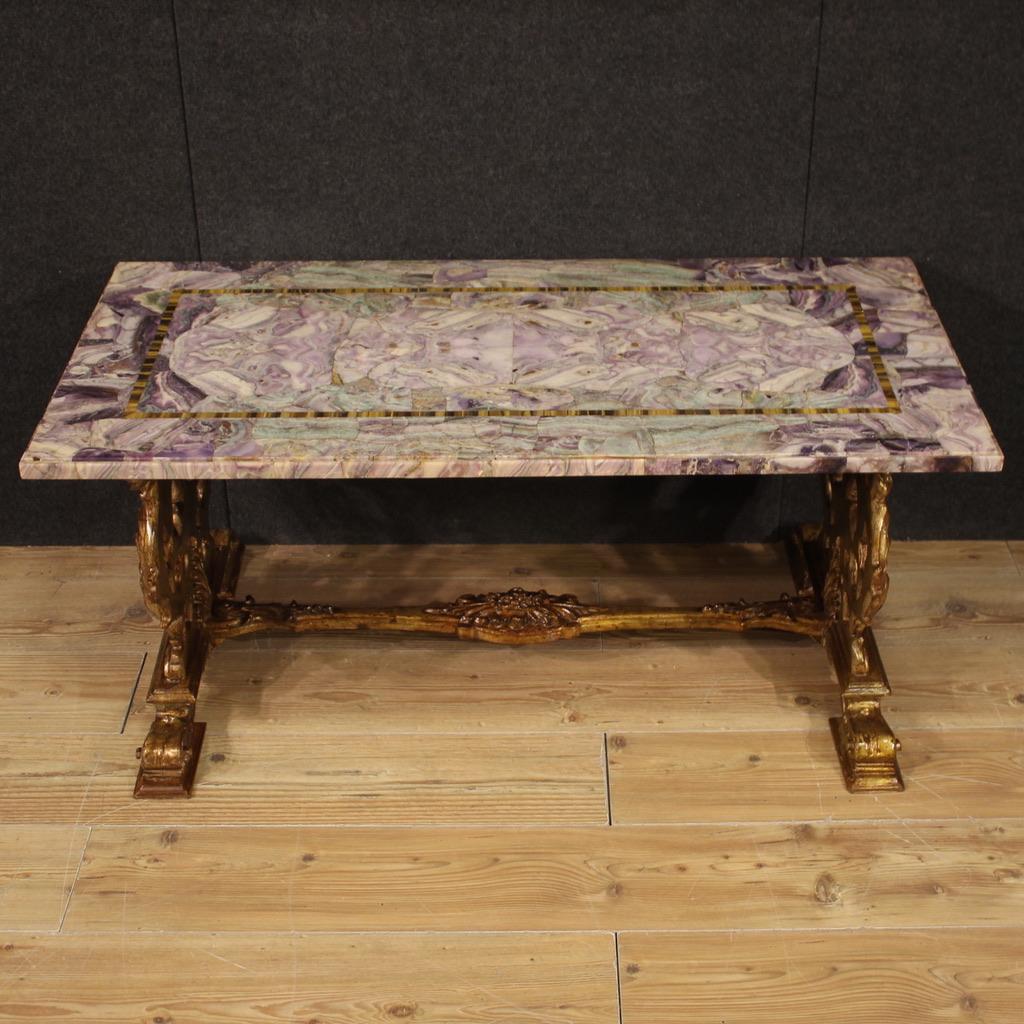 Italian coffe table from the 20th century. Cabinet in carved and gilded wood with excellent quality veneered marble top. Low living room table of nice size and pleasant decor, good size top and service. Hard to find piece of furniture for antique