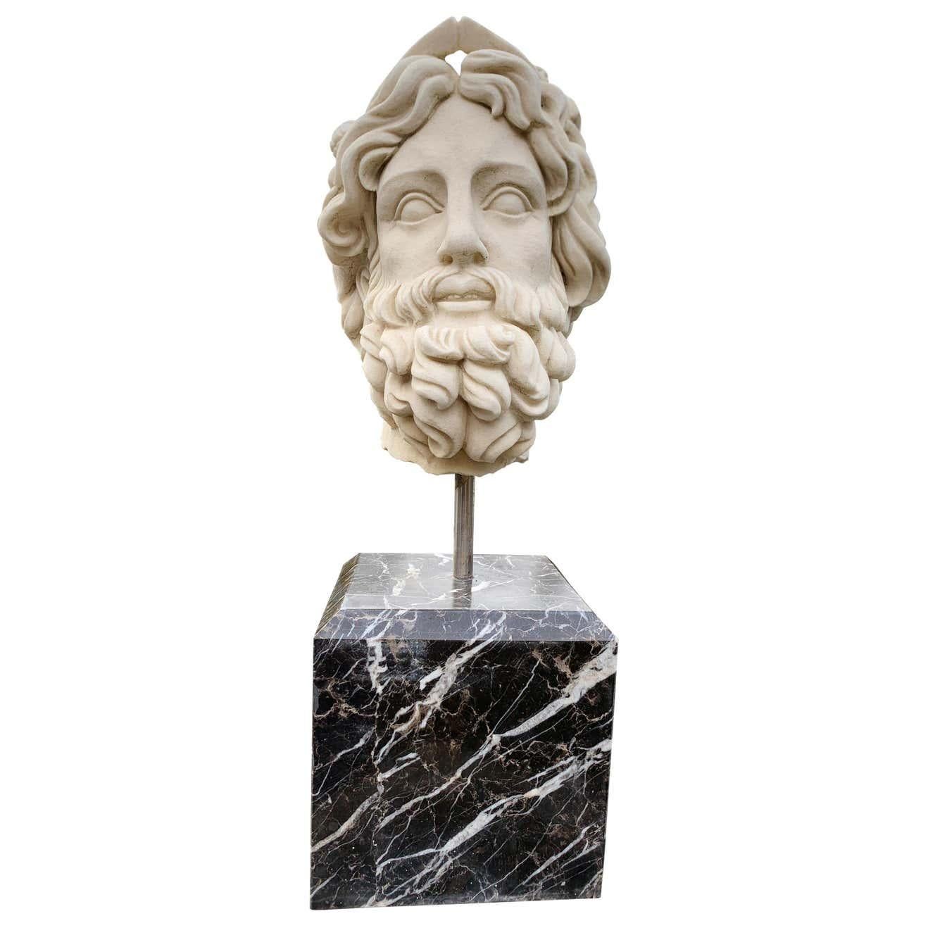 Wonderful marble bust of the Roman God of the water Neptune. Gorgeous piece standing on a black marble pedestal base. We've pictured it on a marble column which is not part of the listing but available. Great piece for adding an air of classical