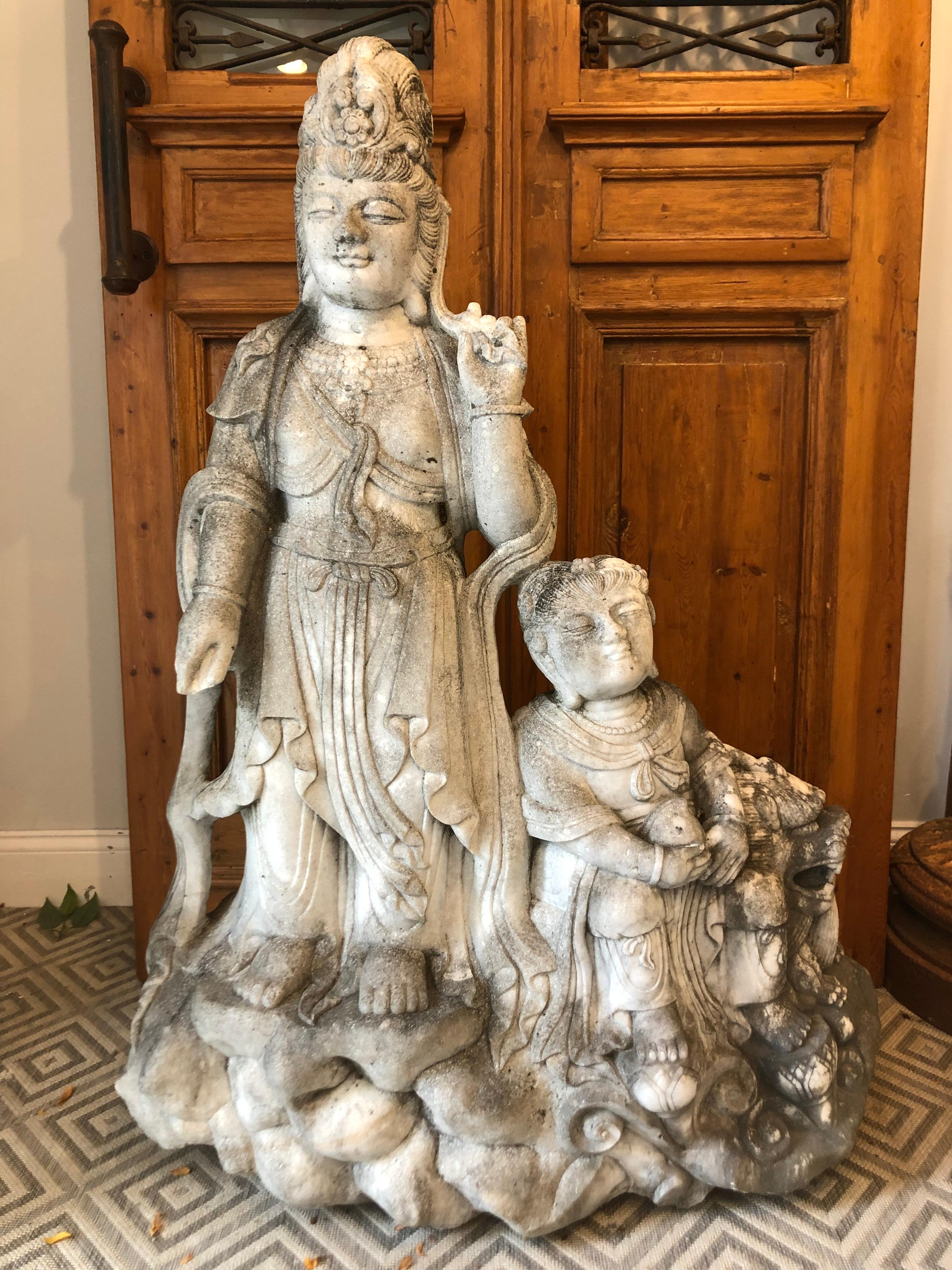 Carved Marble Kwan-Yin Statue with child and foo dog ca 1977 from main land China. Hard to find a Kwan-Yin statue with both child and foo dog its a fantastic piece. This statue would look great in any garden or near any pool a perfect focal point.