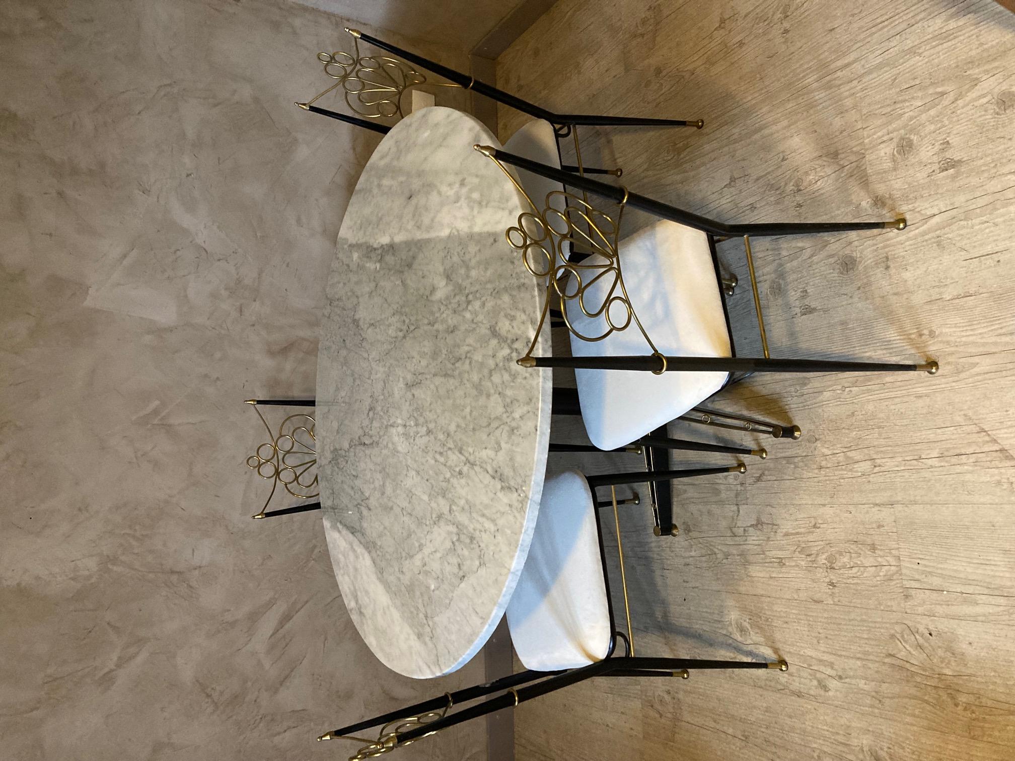 Very nice 20th century Italian rounded table with a grey marble top and a metal and brass base. (removable top from the base)
Four chairs made with a white velvet and also in metal and brass. Beautiful shape. 
very nice quality and condition.
