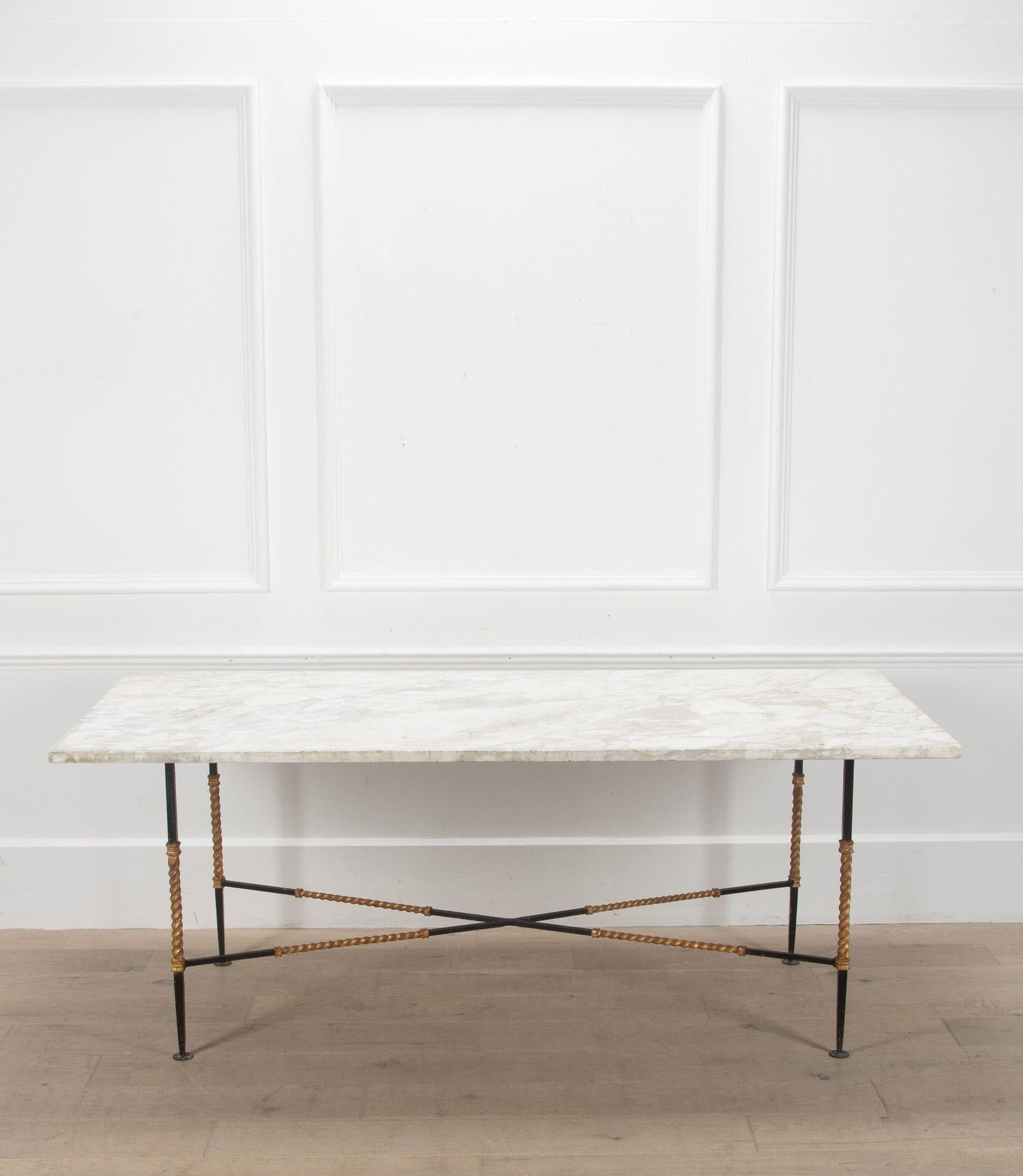 1950s marble top table with a patinated and gilded iron base.