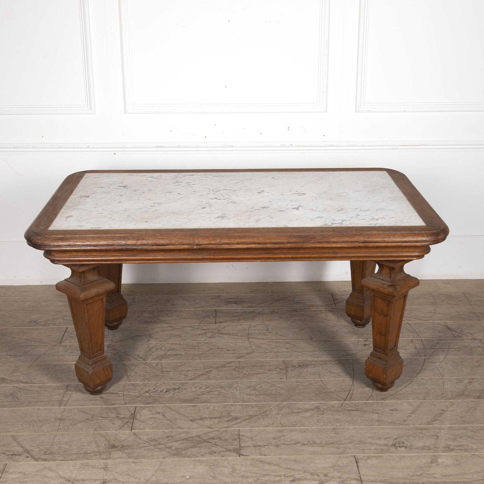 20th century Marble-topped French baker's table.
Dating from the early 20th century, this French oak baker's table has an inset marble top with moulded frieze supported on robust square tapered legs with block feet set at an angle.
This table