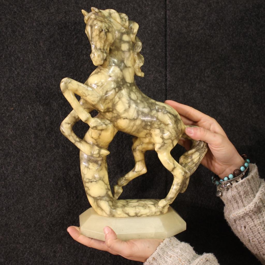 Italian sculpture from the second half of the 20th century. Marble object with alabaster base depicting a prancing horse. Beautifully sized sculpture and decoration for antique dealers, interior decorators and collectors of objects. Horse that shows