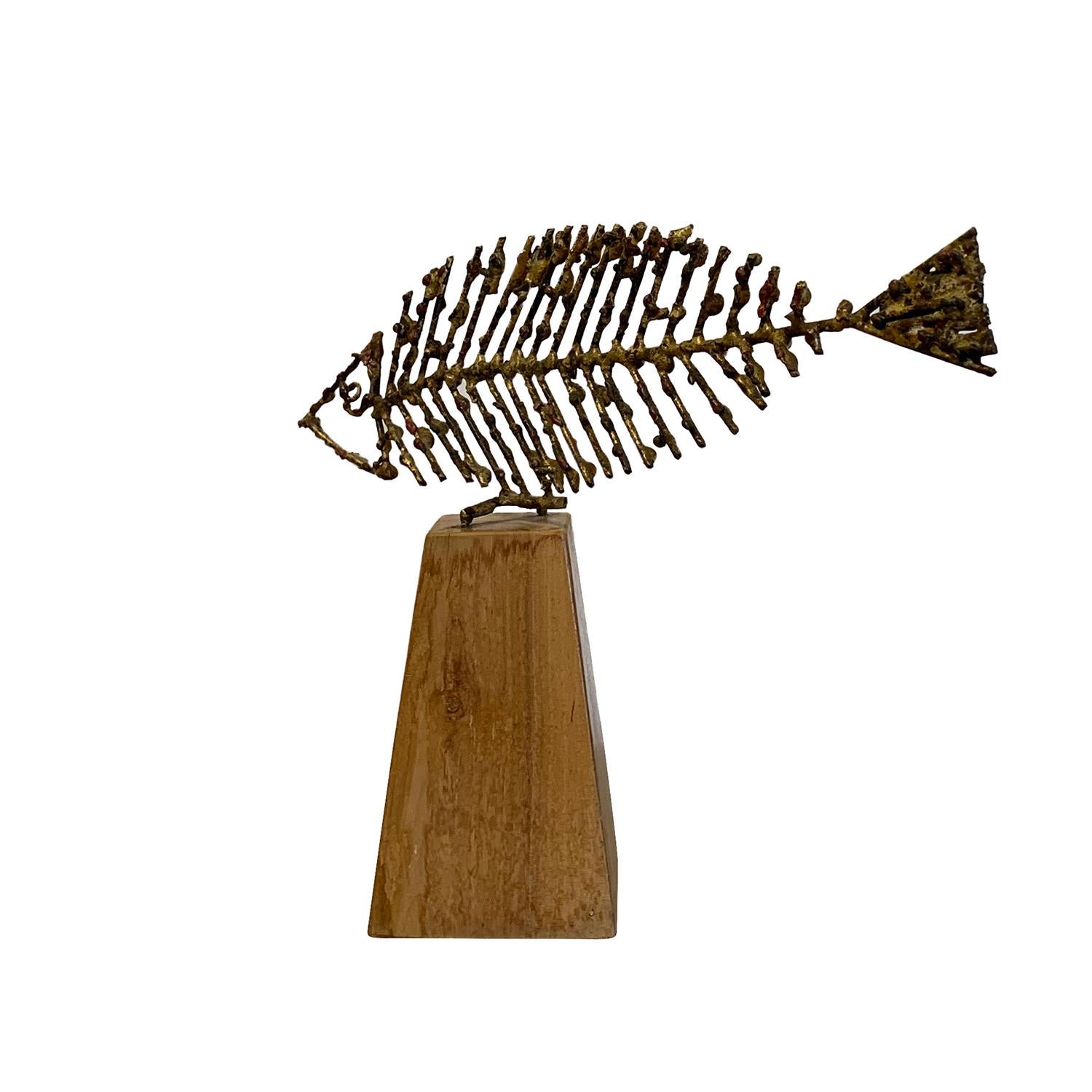 A vintage Mid-Century Modern Italian abstract metal sculpture, a fish on a wood base, signed by Marcello Fantoni, in good condition. As seen in the Metropolitan Museum of Art, Brooklyn Museum and the Victoria Albert Museum in London. Wear consistent