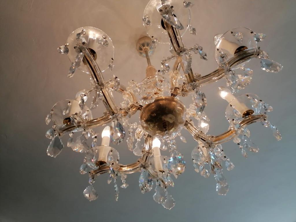 Brass/cut crystal chandelier in Maria Theresia style made in the 1960s probably by Lobmeyr in Vienna.
A beautiful form body. Eight flamed fitted with E14 sockets, rich hangings from the various faceted crystal.