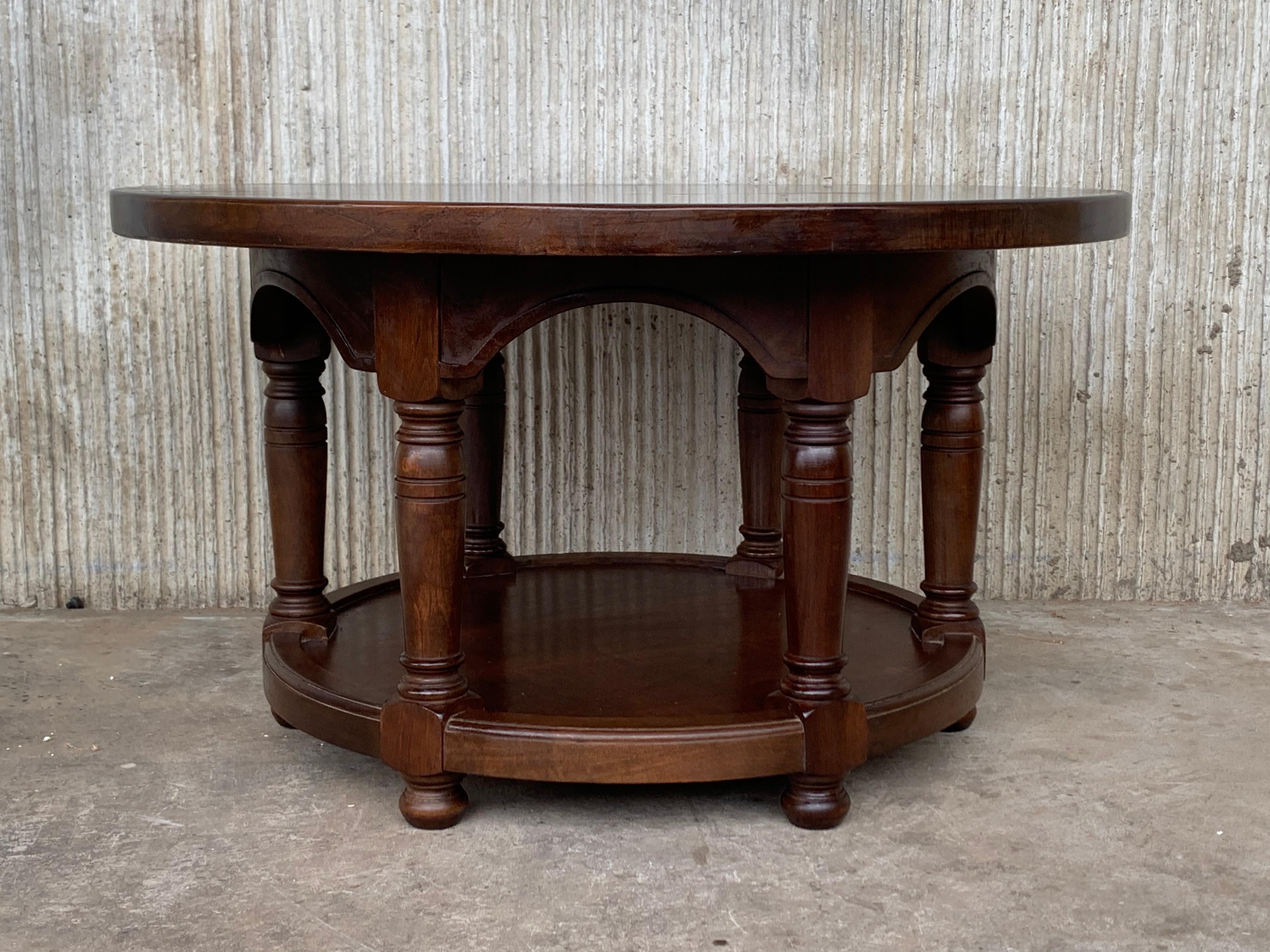 Spanish style two tier round side table with burl top over a richly four legs from the 20th century. 
The old age patina shows the history of the piece. Perfect to be used as a side table, coffee table or nightstand.