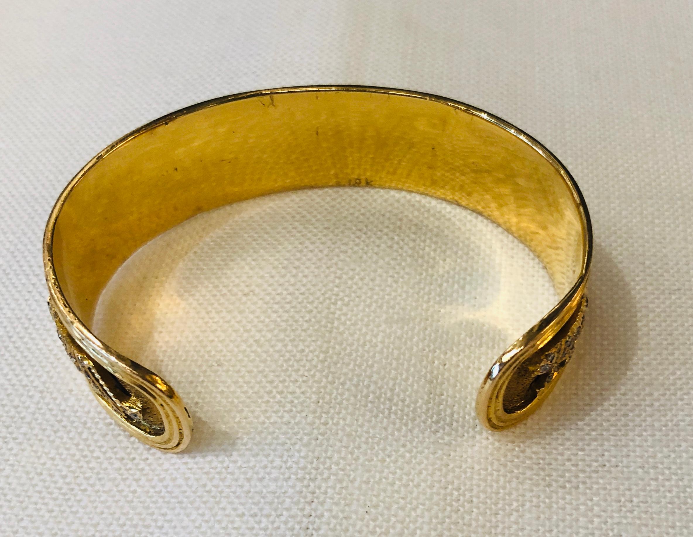 Offered is a 20th century stamped 18-karat yellow gold with diamond encrusted panthers motif cuff bracelet. The cuff is bordered by two shiny gold bands on the top and the bottom. Inside the bands are seven diamond encrusted gold panthers with a