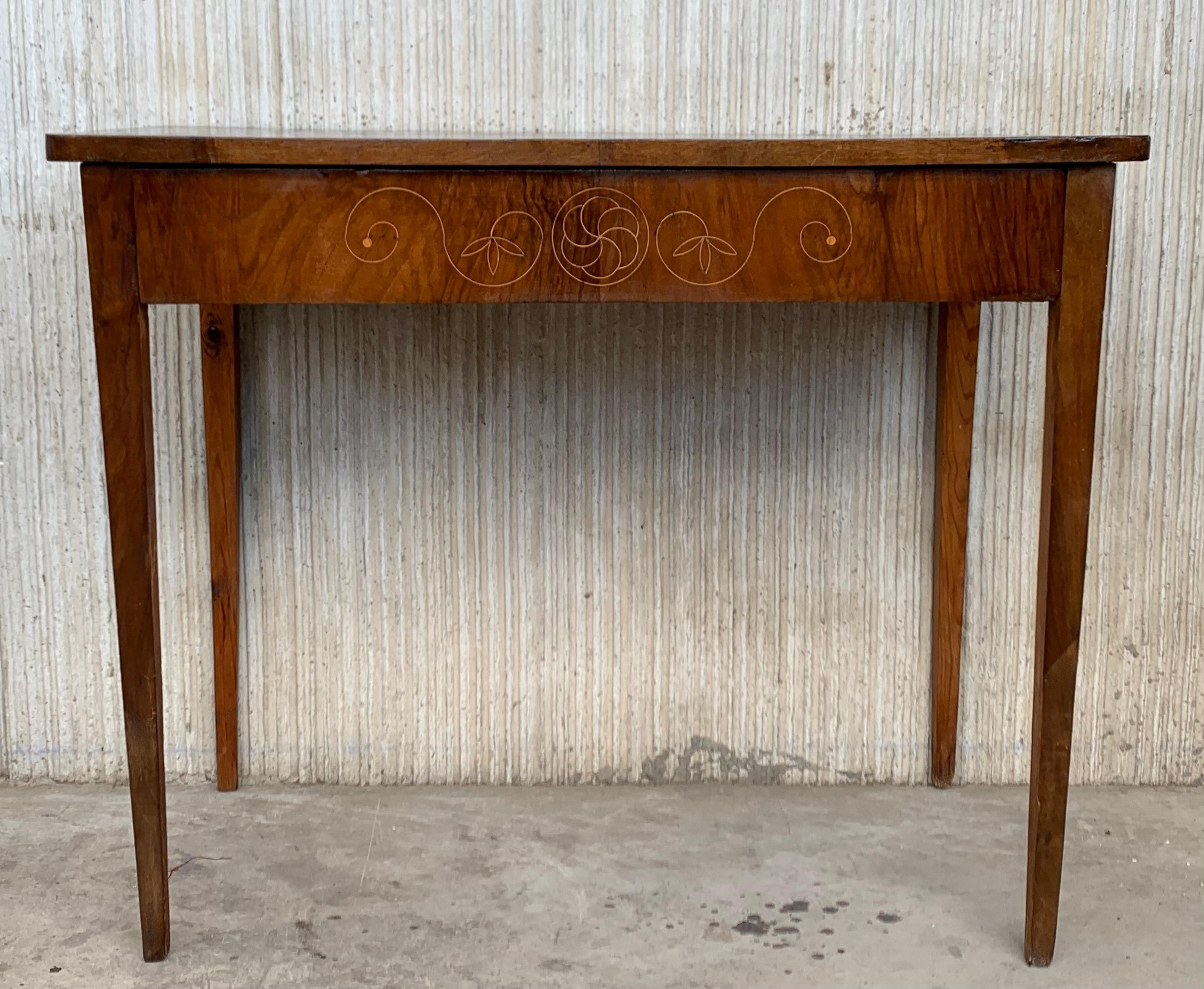 Early 20th century console in wood veneer. It features beautiful marquetry of rinceaux and floral motifs in drawer. It is resting on four tapered legs.