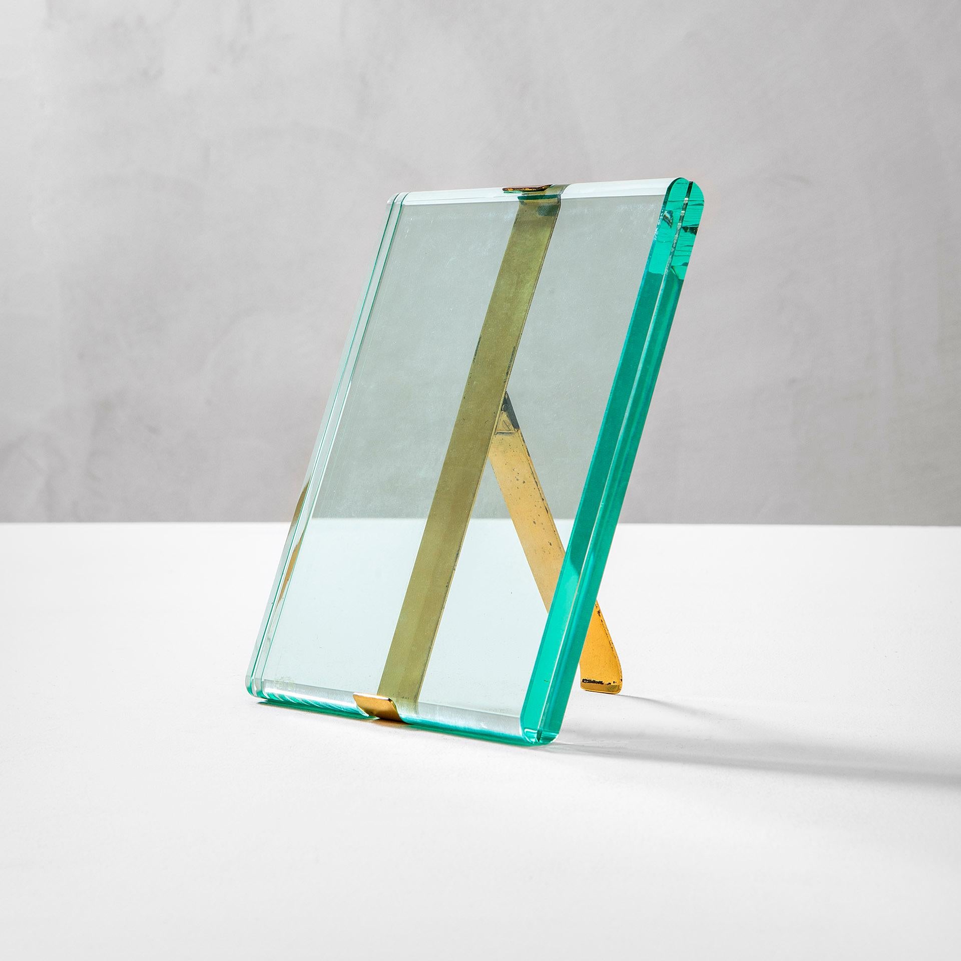 Picture frame model n. 1371 designed by Max Ingrand for Fontana Arte in 1960s. The picture frame is in glass and brass, with its own patina of time.