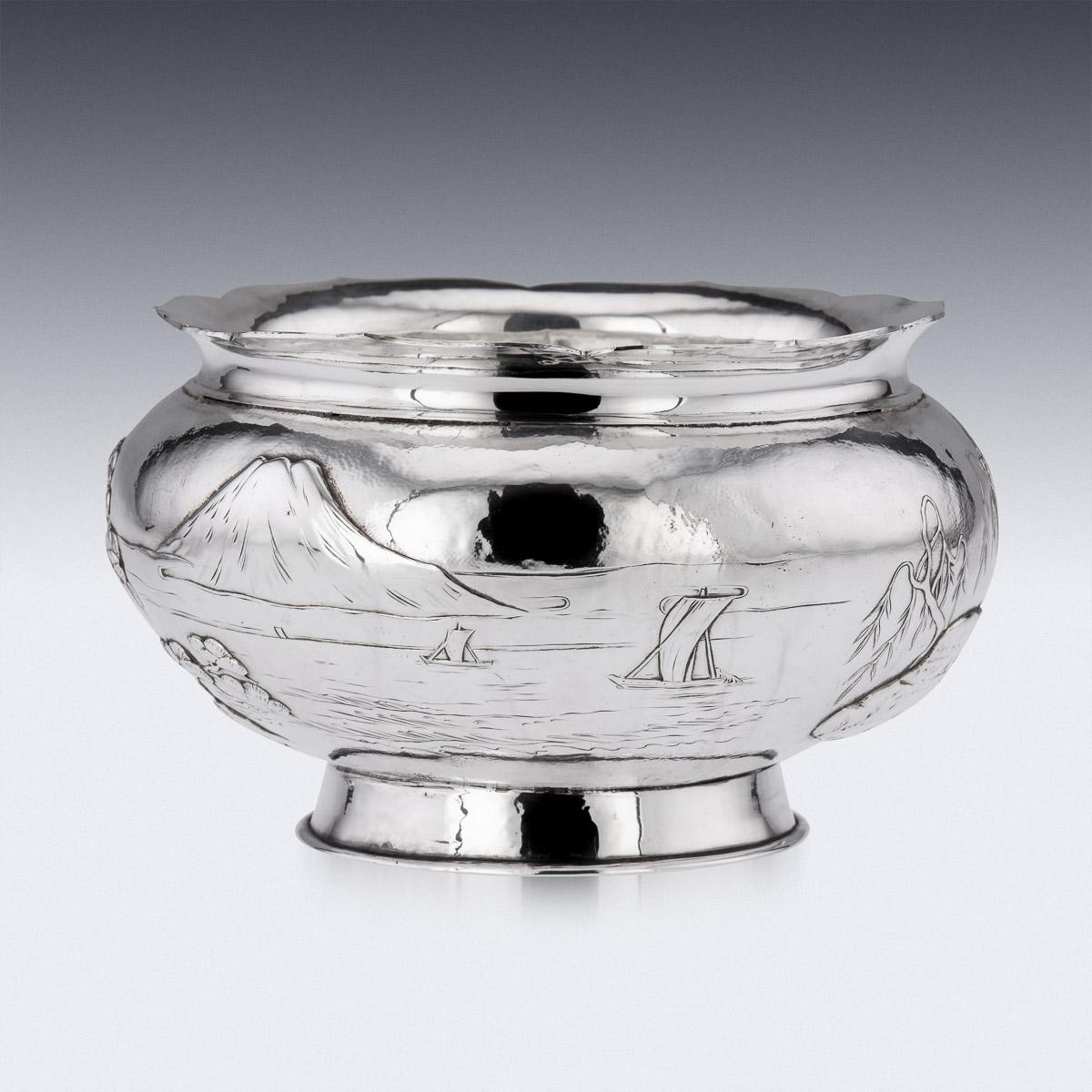 20th Century Japanese Meiji period silver bowl, double walled, depicting the view of mount Fuji from a lake, with boats and small island with banzai trees, on a matted hand hammered ground. The top applied with a shaped floral rim and standing on a