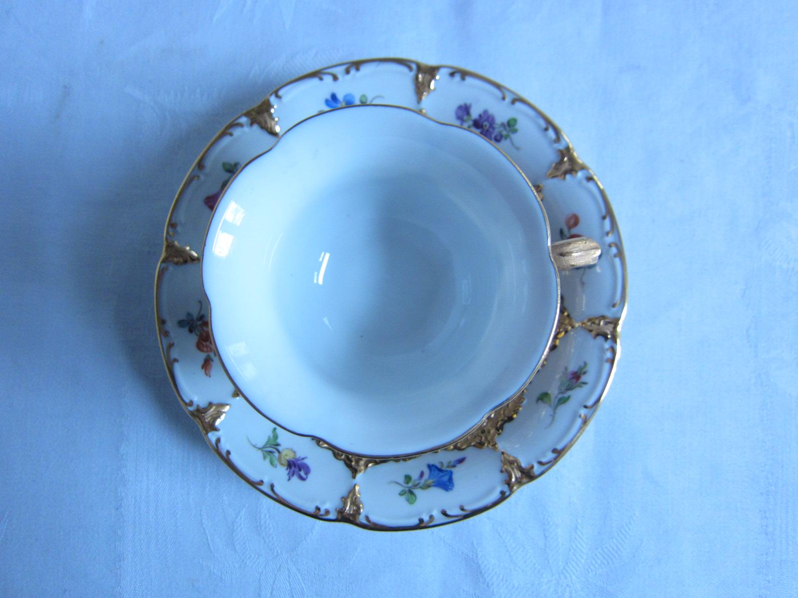 Meissen Porcelain coffee cup with saucer richly hand painted decorated with gold.