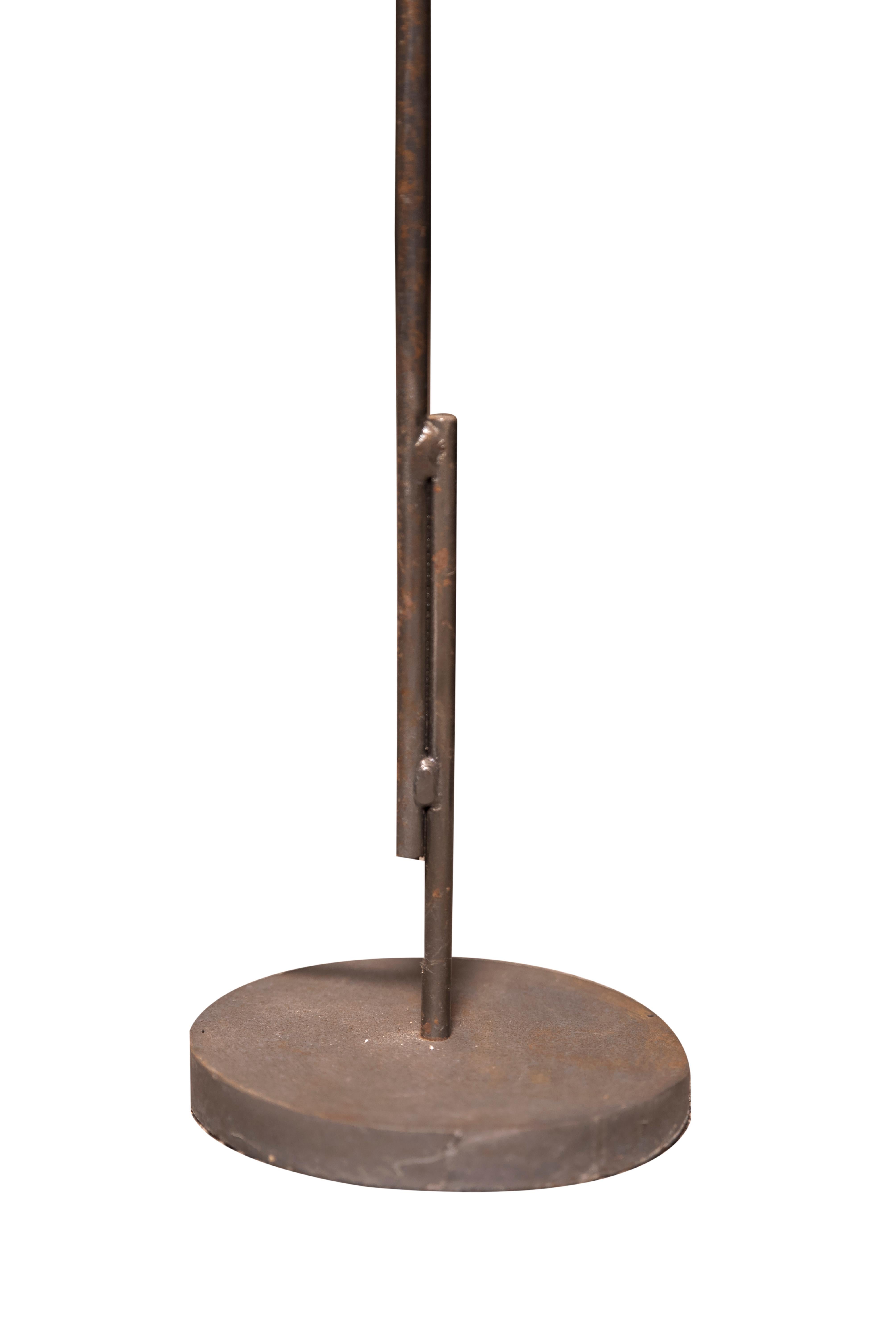 20th century metal floor lamp attributed to Franz West. The circular shade with black floral pattern on green groung above a plain round stem.
The two part shaft soldered near the circular base and with tall cilindrical shade is same as the West´s