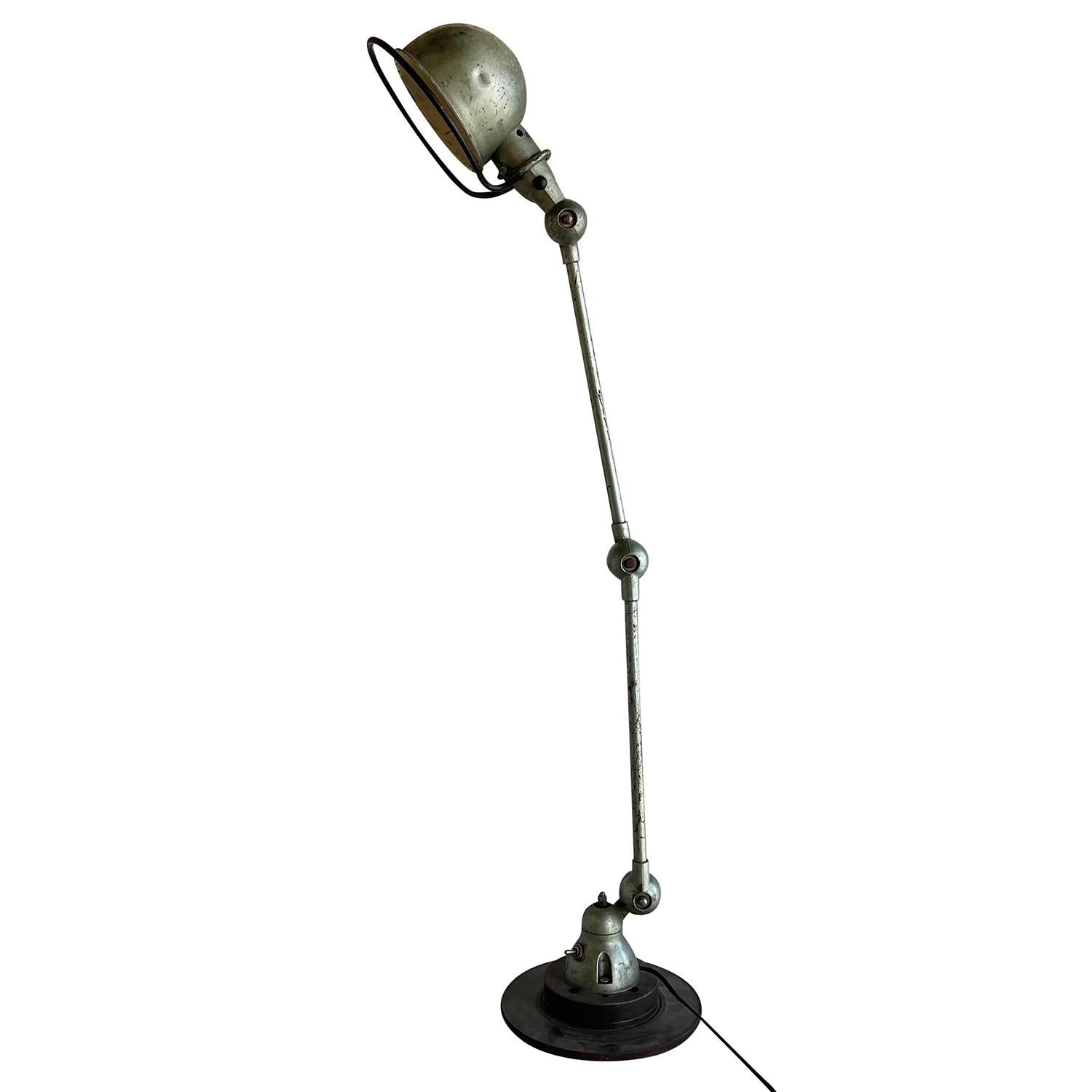 A metallic-green, vintage Mid-Century Modern French desk light made of hand crafted metal, designed by Jean Louis Domecq and produced by Jielde, in good condition. The Industrial car brake, table lamp is composed with two adjustable arms, featuring