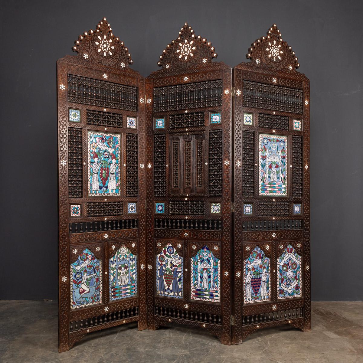 Striking 20th century Middle-Eastern folding screen / room divider. This exquisite screen consists of dark polished wood and mother of pearl inlay and hand painted enamel panels. Perfect for indoor and outdoor use, this is a real conversation piece