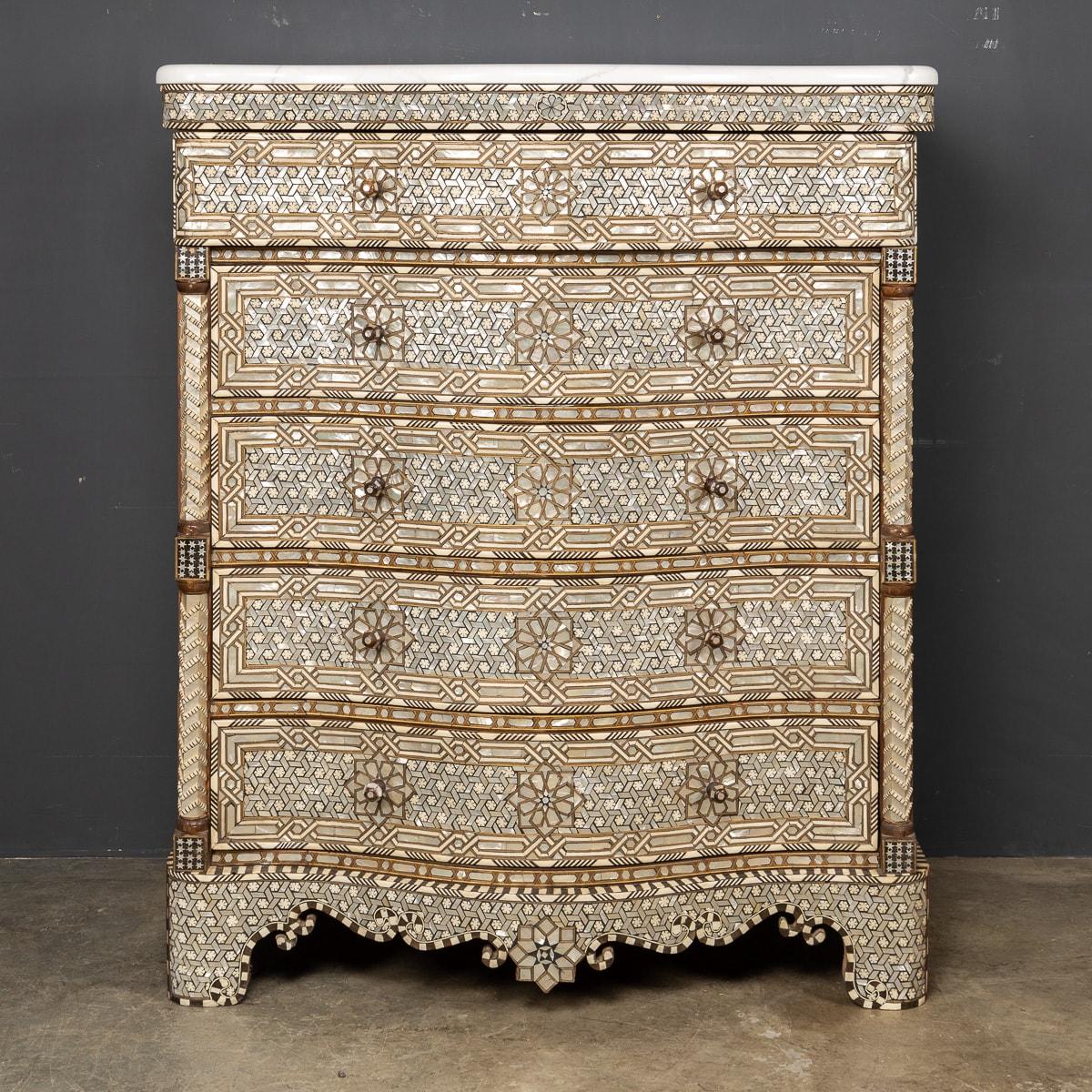 A truly stunning mid-20th Century Middle Eastern chest inlaid with intricately carved patterns of mother of pearl and bone. This piece has carved handles and set with a marble top, five drawers in total.

CONDITION
In Great Condition - No