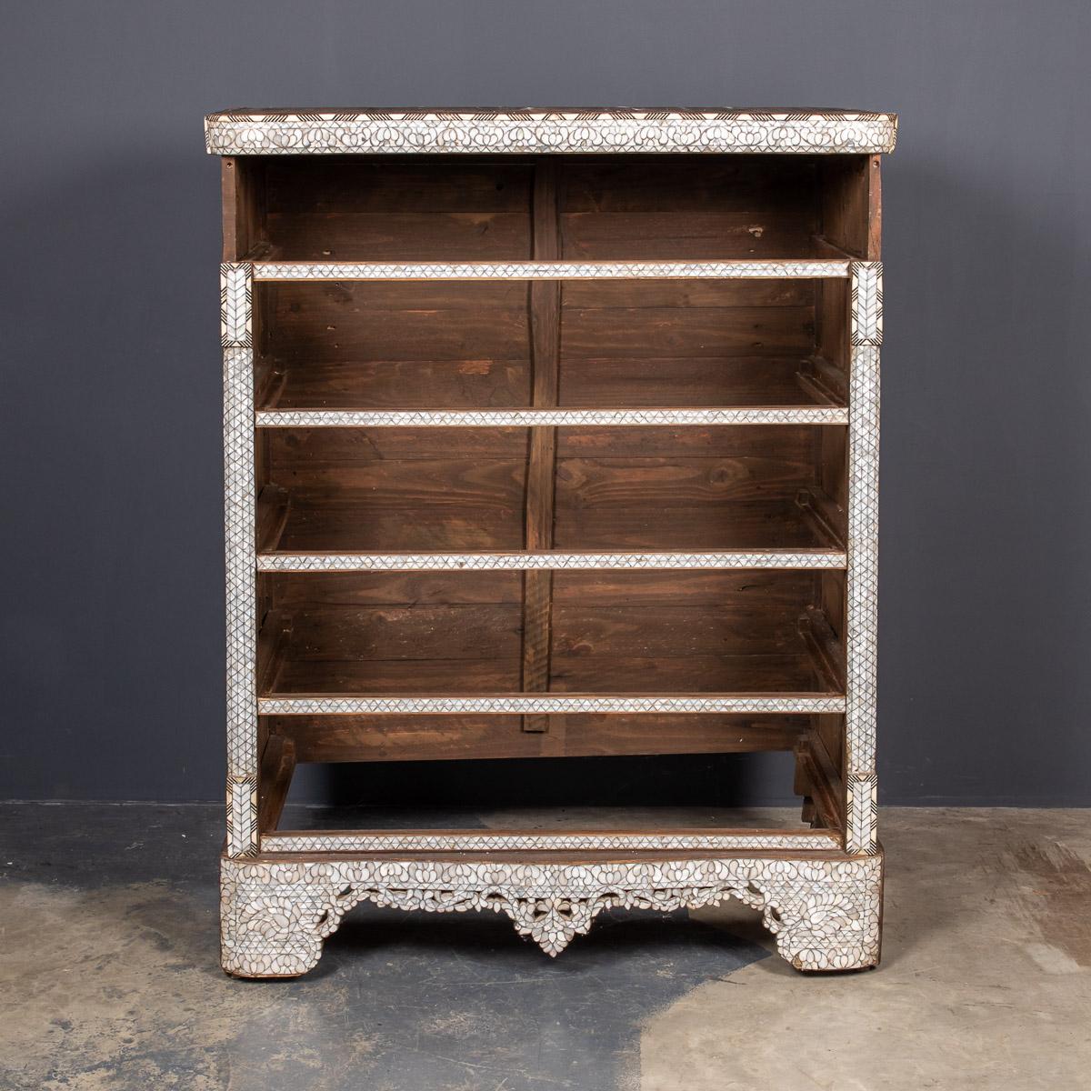 Antique early-20th century Middle-Eastern mother of pearl decorates the front of this beautiful five drawer chest. The handles are carved from camel bone and set in a daisy style inlay. This piece has a curved, white marble top and beveled wooden