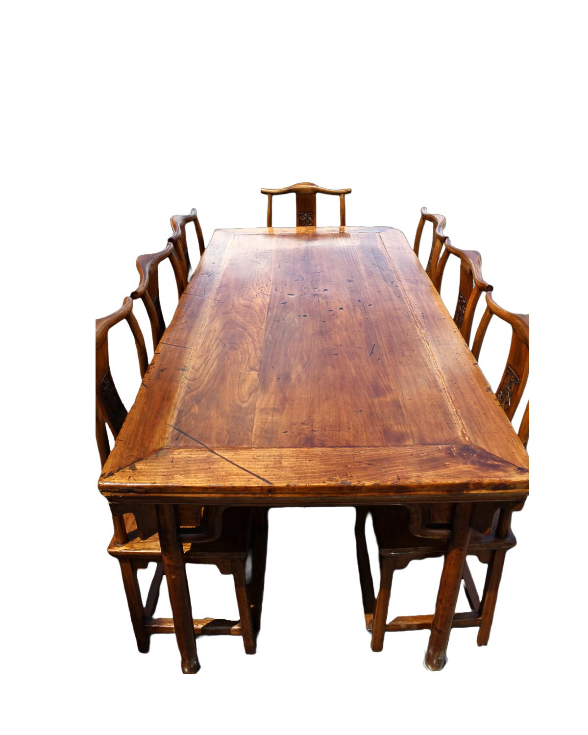 A set of 9 pieces in the style of Ming dynasty. Table features a long rectangular planked top sitting above an graceful apron, enhanced with carved linear scrolls on the spandrels,. Raised on four cylindrical legs, the table features a lovely patina
