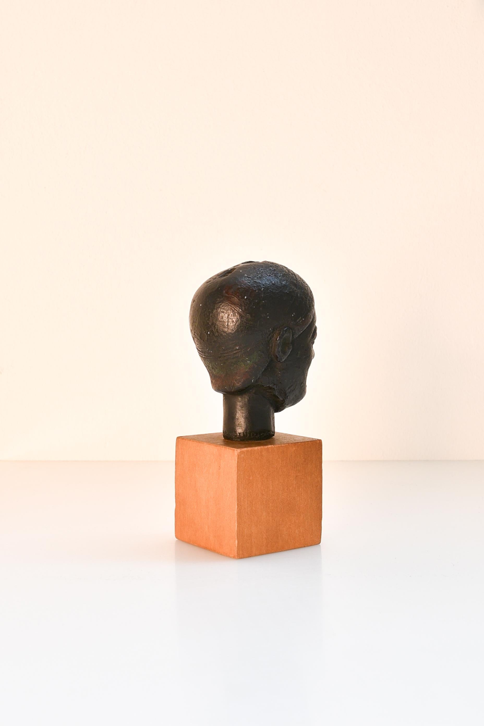 Hand-Crafted 20th century miniature black terracotta head of a woman, mounted on wood